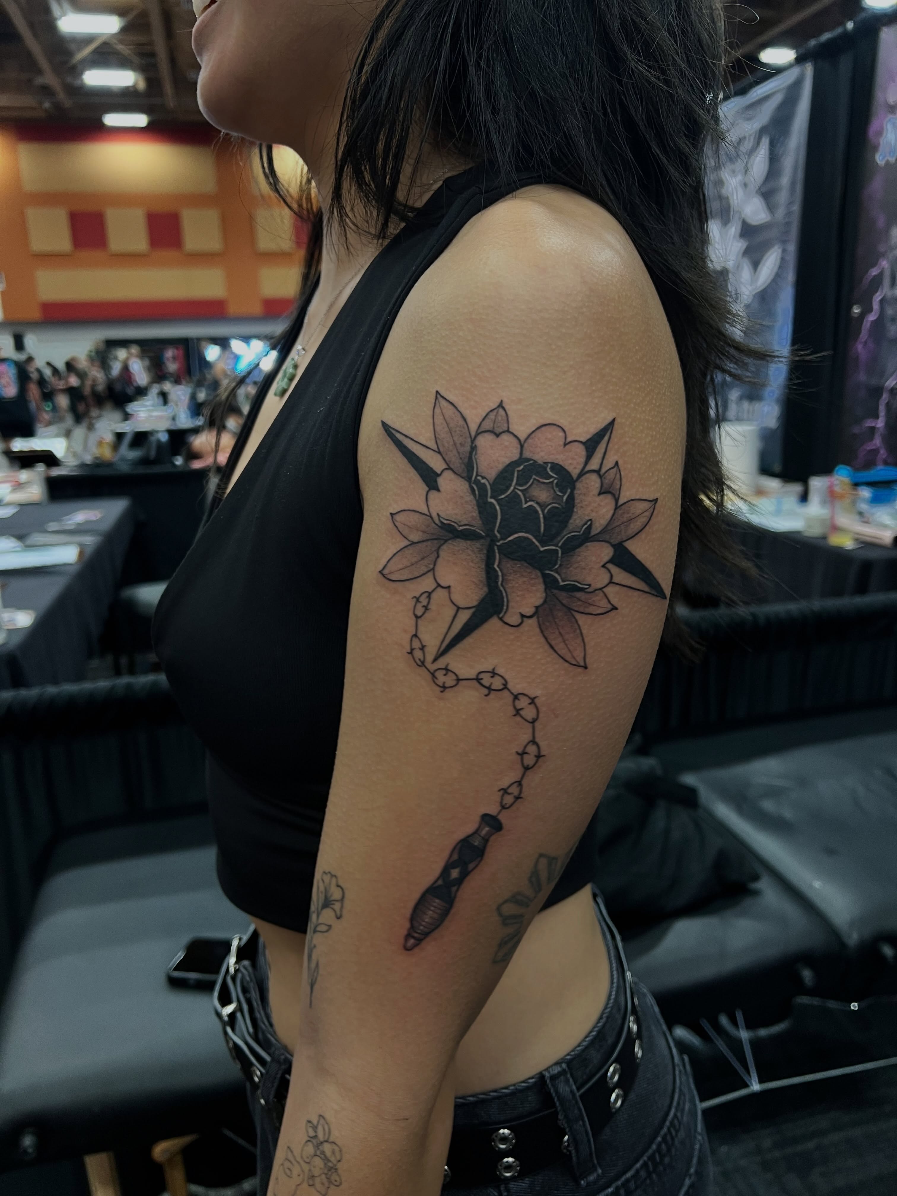 Flower and dagger black and grey tattoo on the forearm by 𝖑𝖎𝖑 𝖗𝖎𝖘𝖘