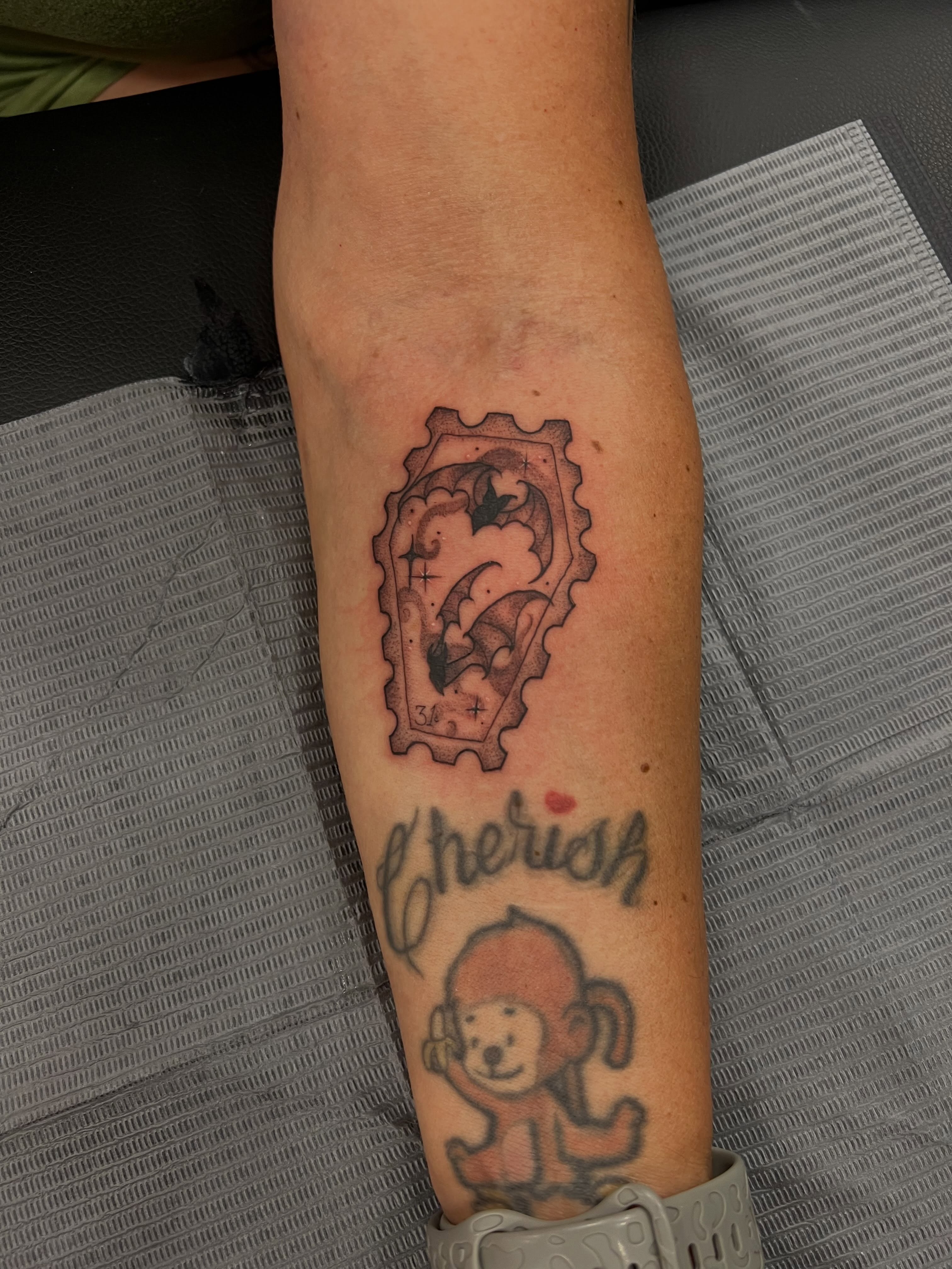 Ticket with dragon black and grey tattoo on the forearm by 𝖑𝖎𝖑 𝖗𝖎𝖘𝖘