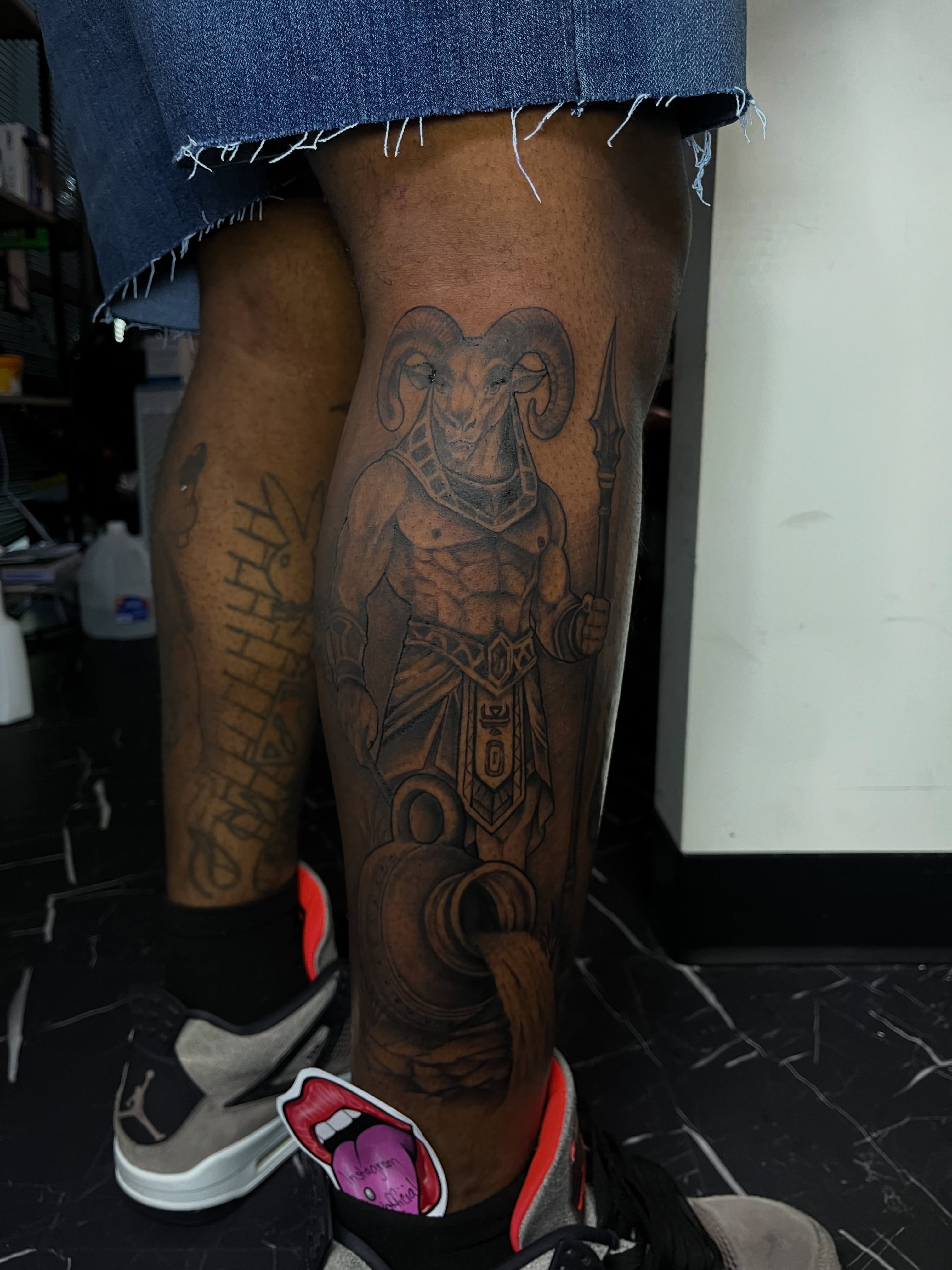 Ram warrior black and grey tattoo on the leg by Doll The Tattoo Artist, Addison, Texas