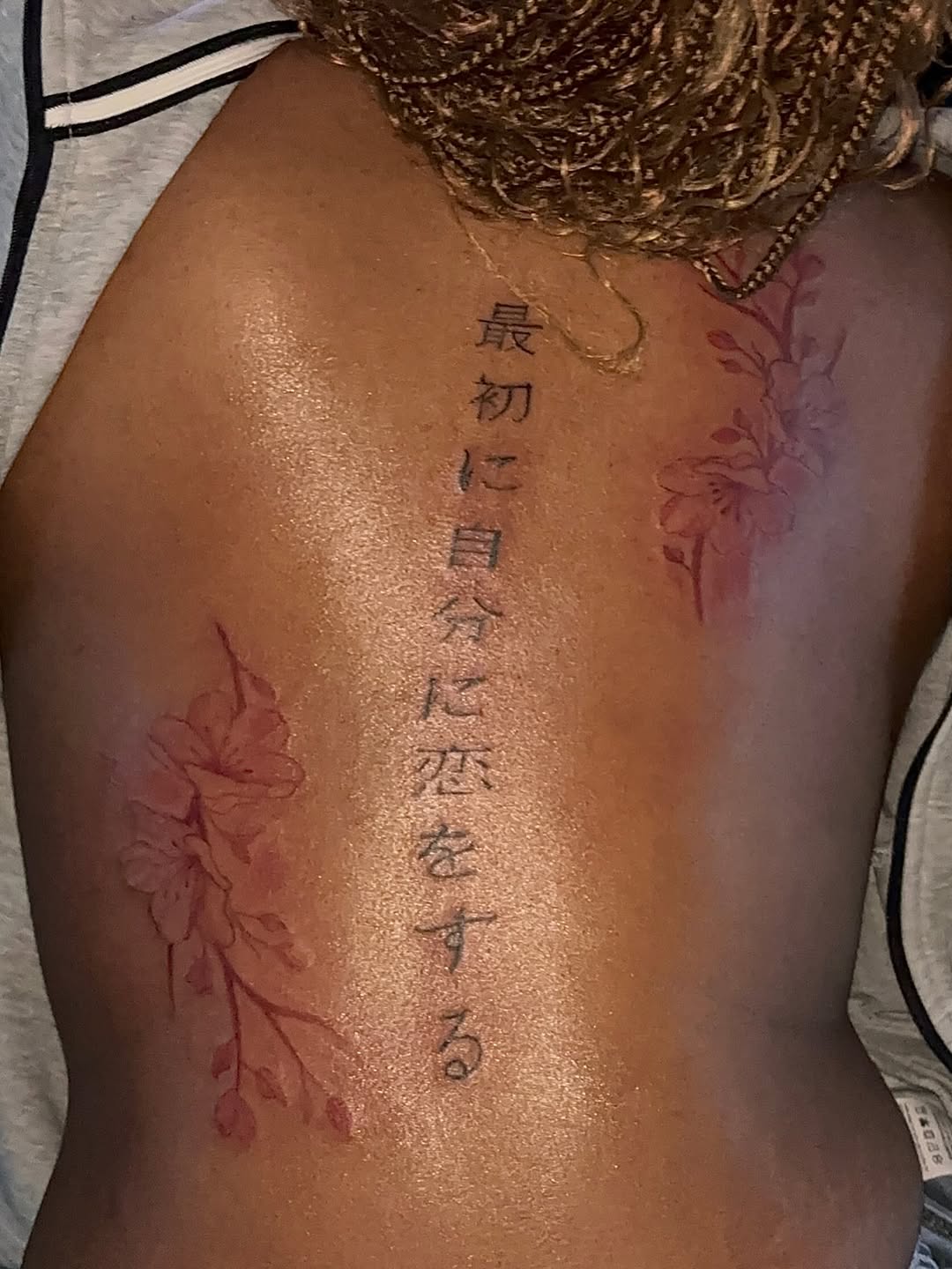 Japanese script and cherry blossoms tattoo on the back by GasPaccInk