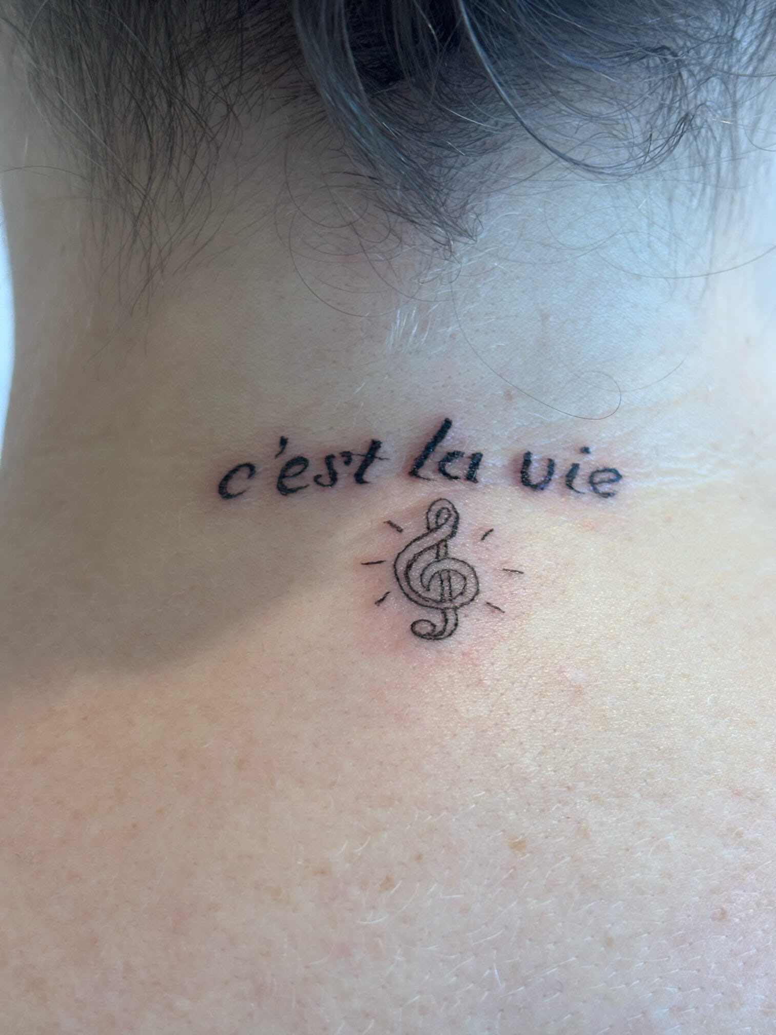 C'est la vie lettering script tattoo on the neck by Malissa