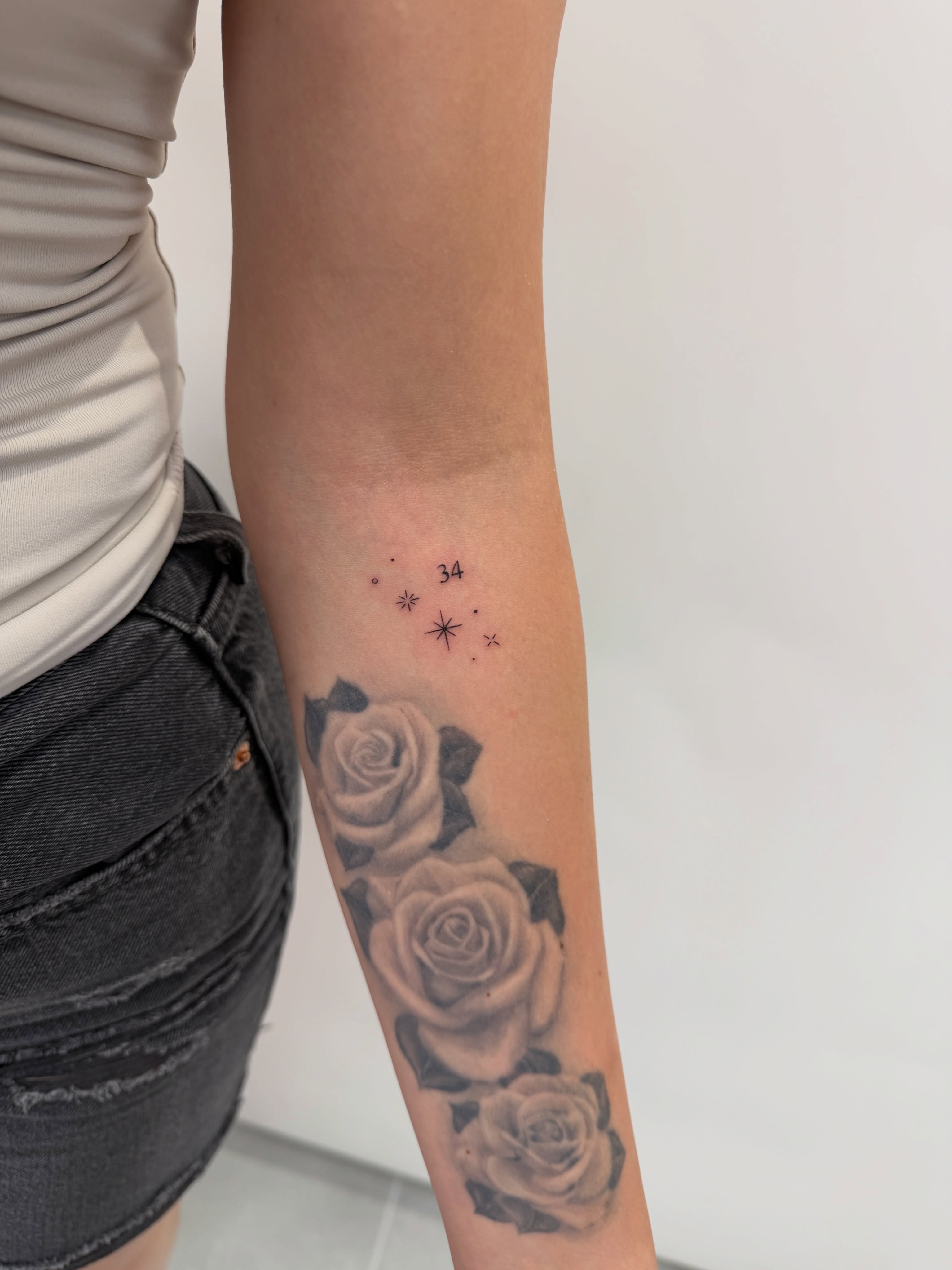 Roses and stars realism tattoo on the forearm by Alex