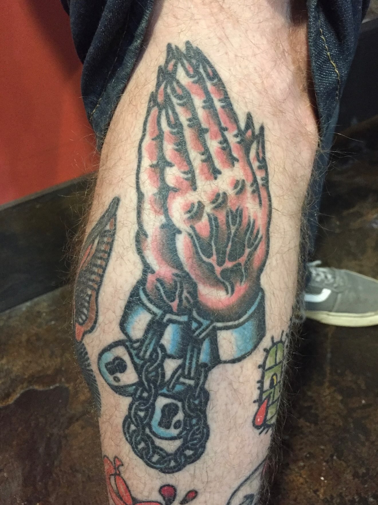 Praying hands American traditional tattoo on the forearm by Steve Pearson