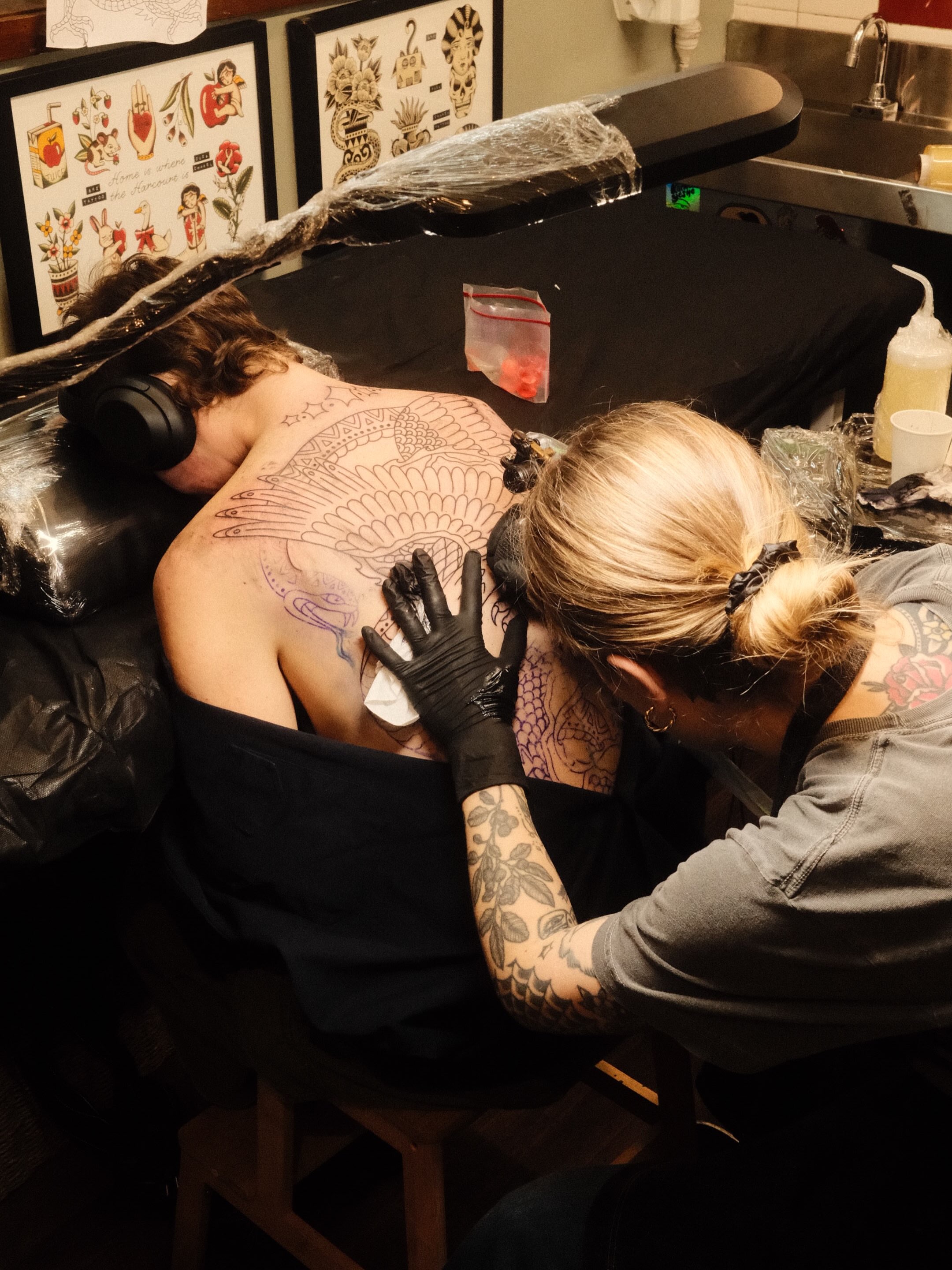 Feathered bird American traditional tattoo on the back by Jonathan Clapp, San Antonio, Texas