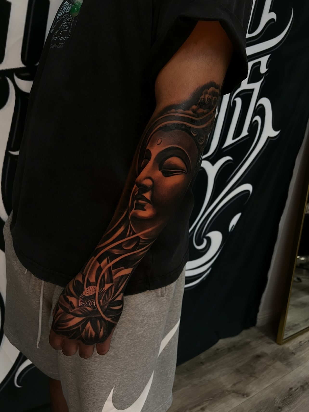 Buddha head realism tattoo on the forearm by Daniel Michael Perez