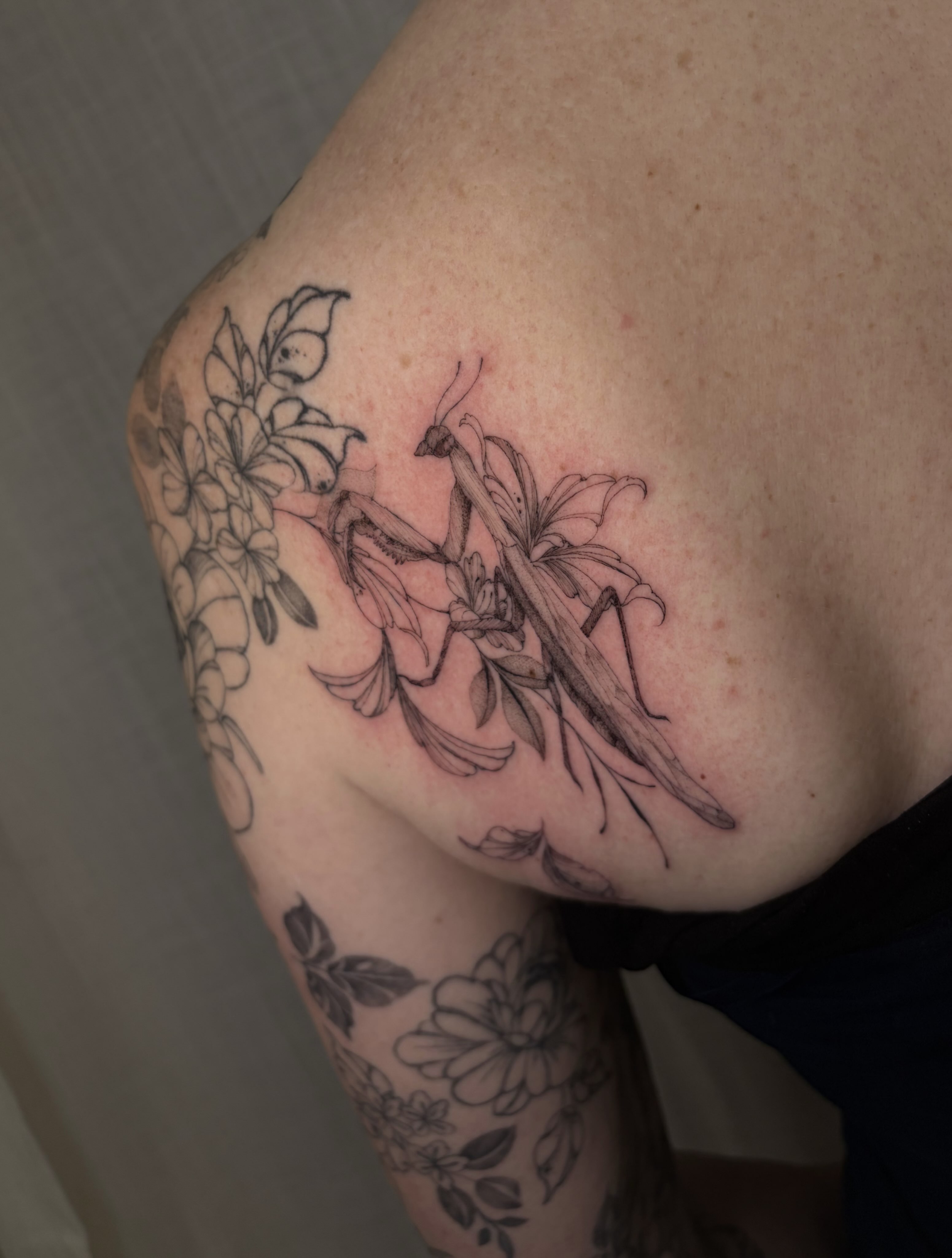 Lilies and floral arrangement black and grey tattoo on the shoulder by Justene Renee 🖤 Fine Line Tattoo Artist
