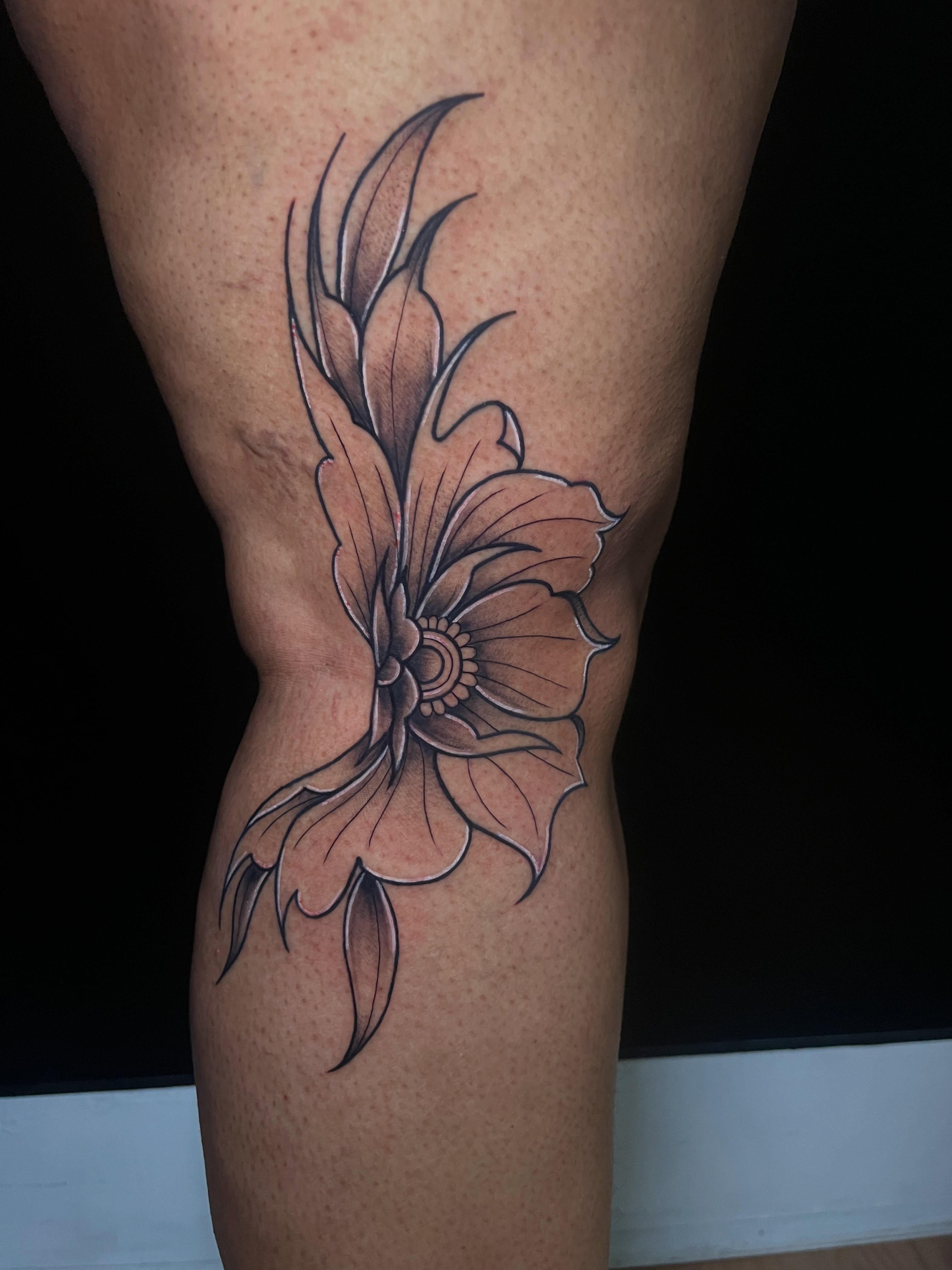 Flower black and grey tattoo on the thigh by Baung Ben