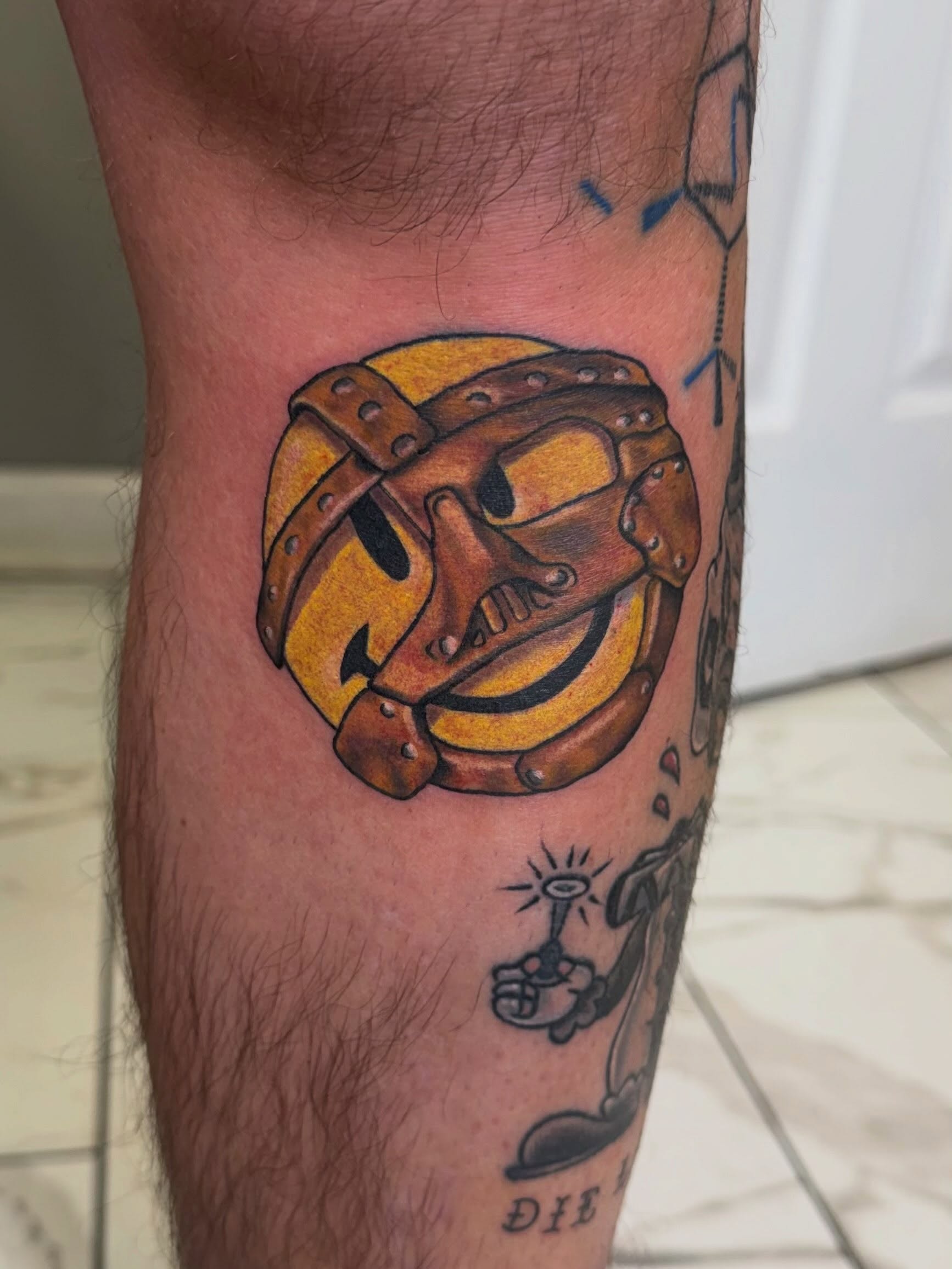 Football helmet American traditional tattoo on the calf by linda perez
