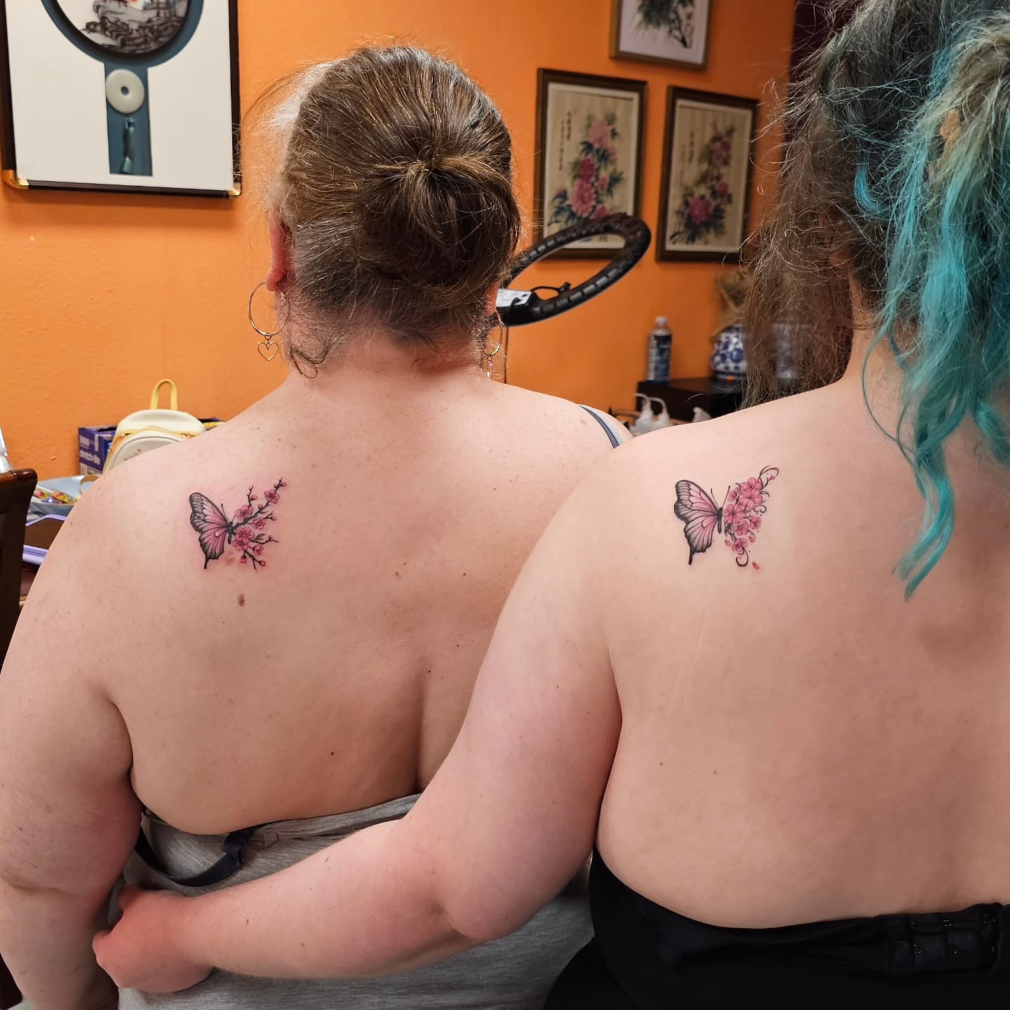 Butterfly and cherry blossoms realism tattoo on the back by Lili Gu