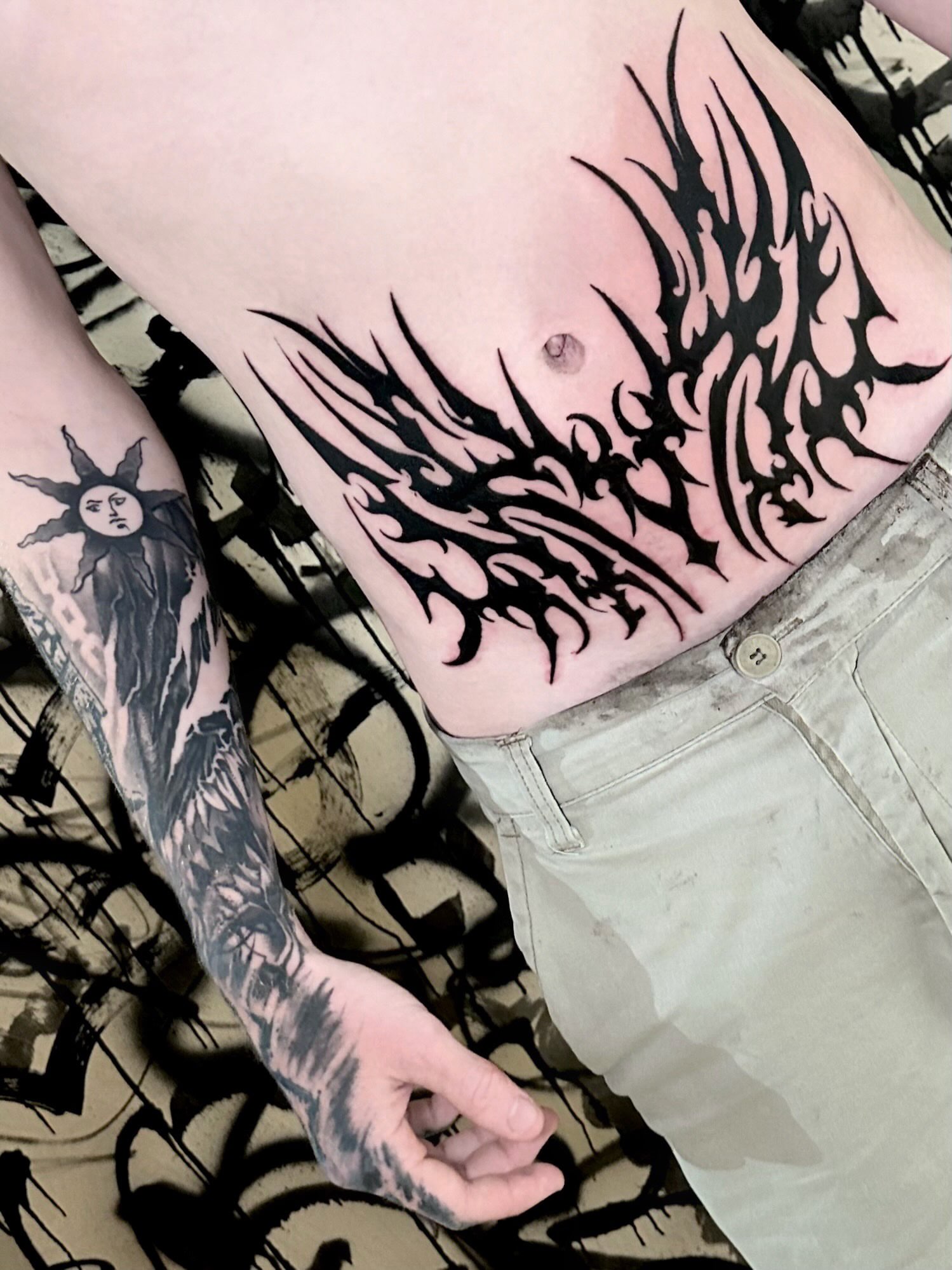 Flame tribal tattoo on the torso by Italo Holie