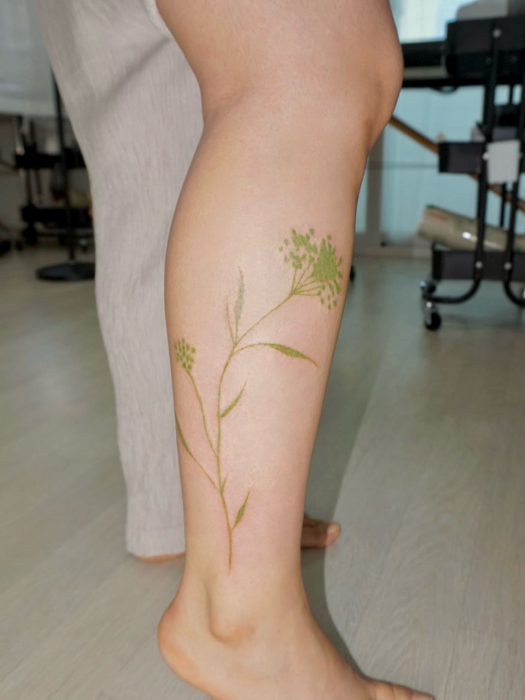 Flower fine line tattoo on the calf by 매실 * handpoke