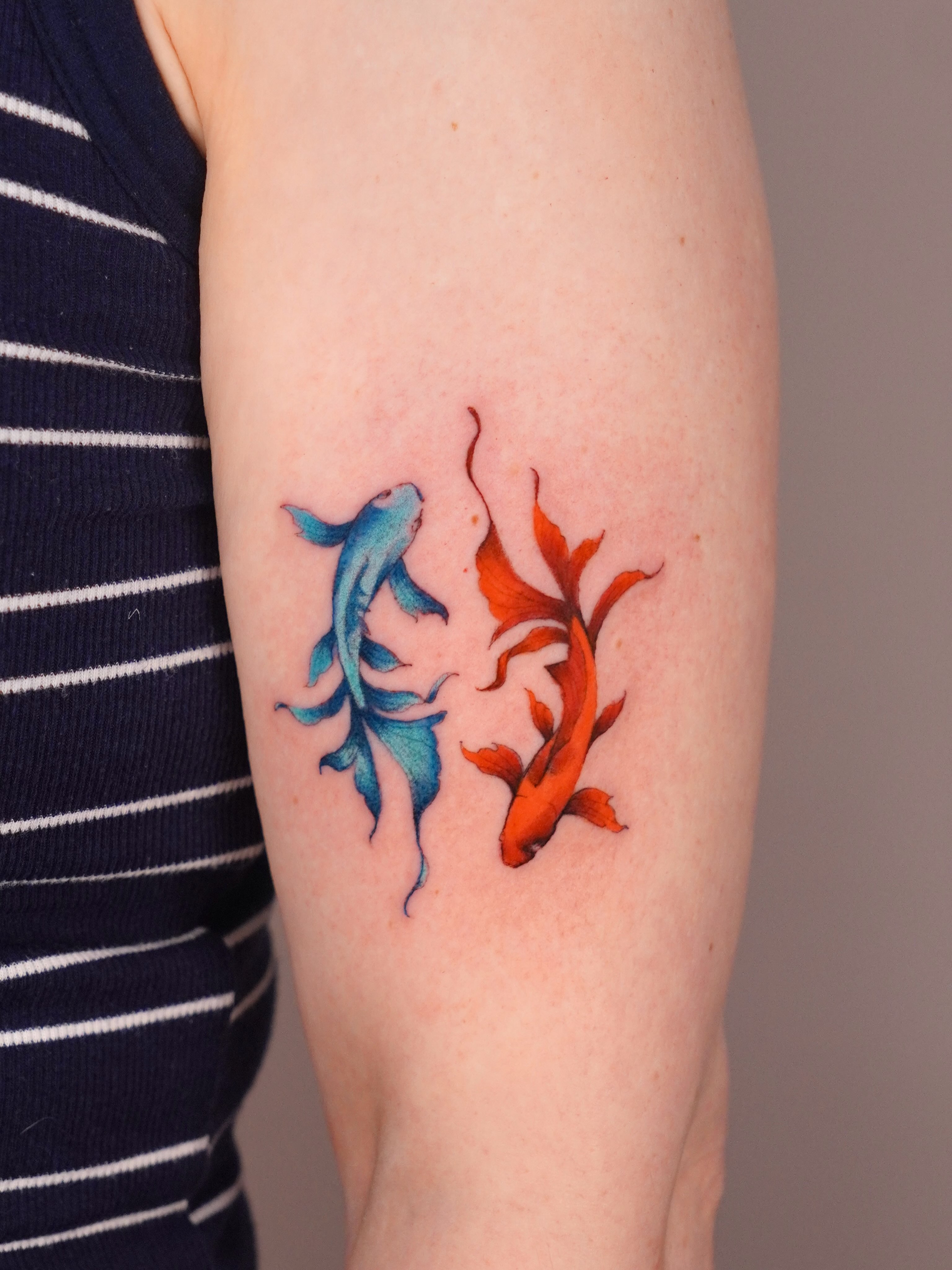 Koi fish watercolor tattoo on the forearm by Marianna D D King