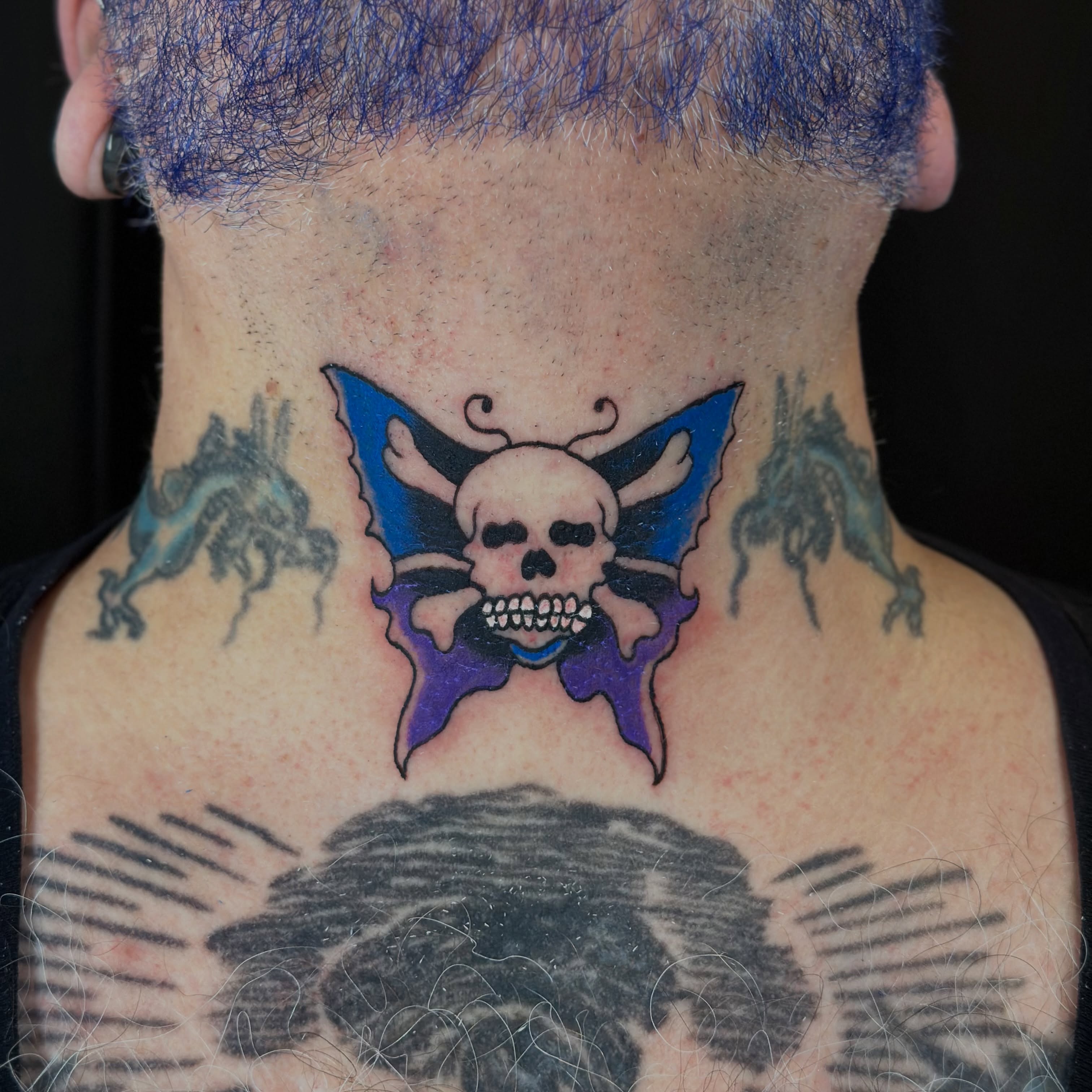 Skull and butterfly neo-traditional tattoo on the neck by Tyyler Santor (Tattoo Artist), Somerville, Massachusetts