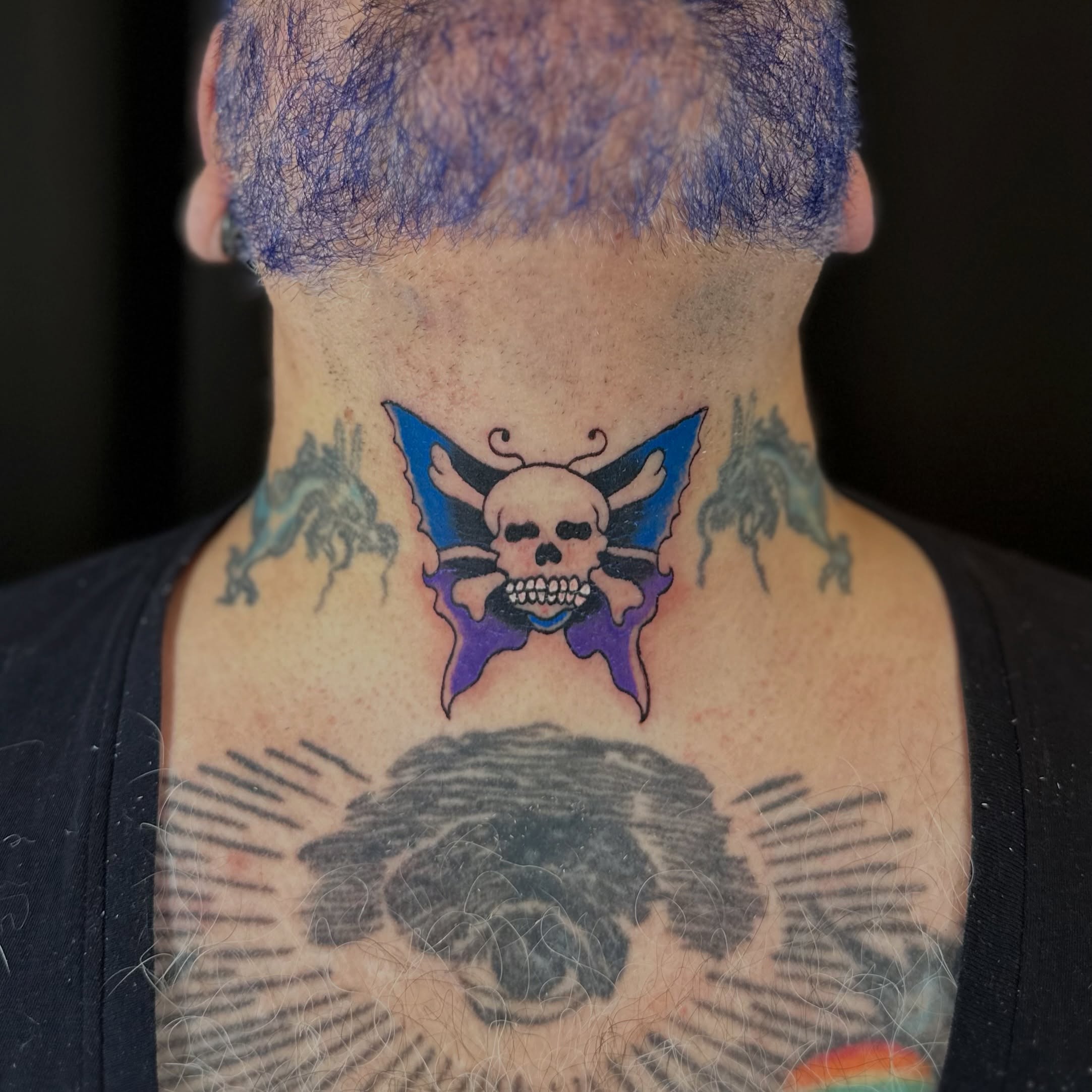 Skull and butterfly American traditional tattoo on the neck by Tyyler Santor (Tattoo Artist), Somerville, Massachusetts