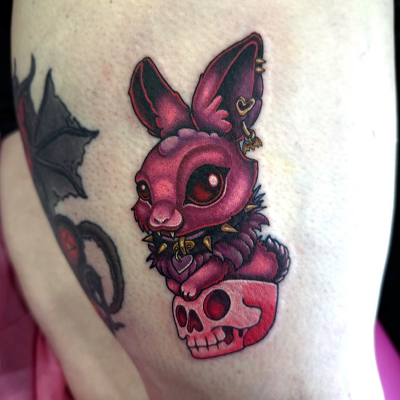 Bat and skull American traditional tattoo on the thigh by Alexandra Fische