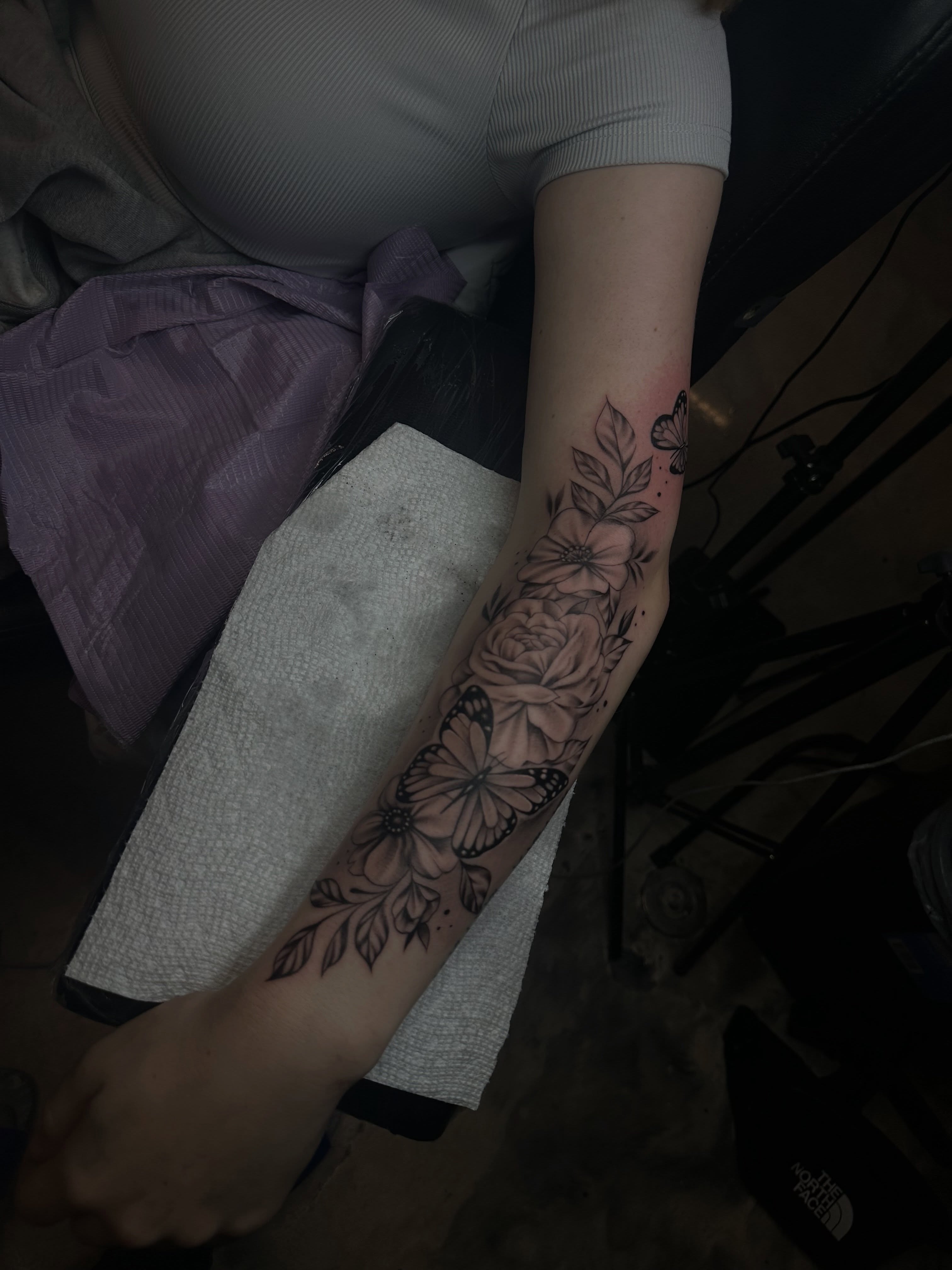 Floral bouquet black and grey tattoo on the forearm by Jay Daartist