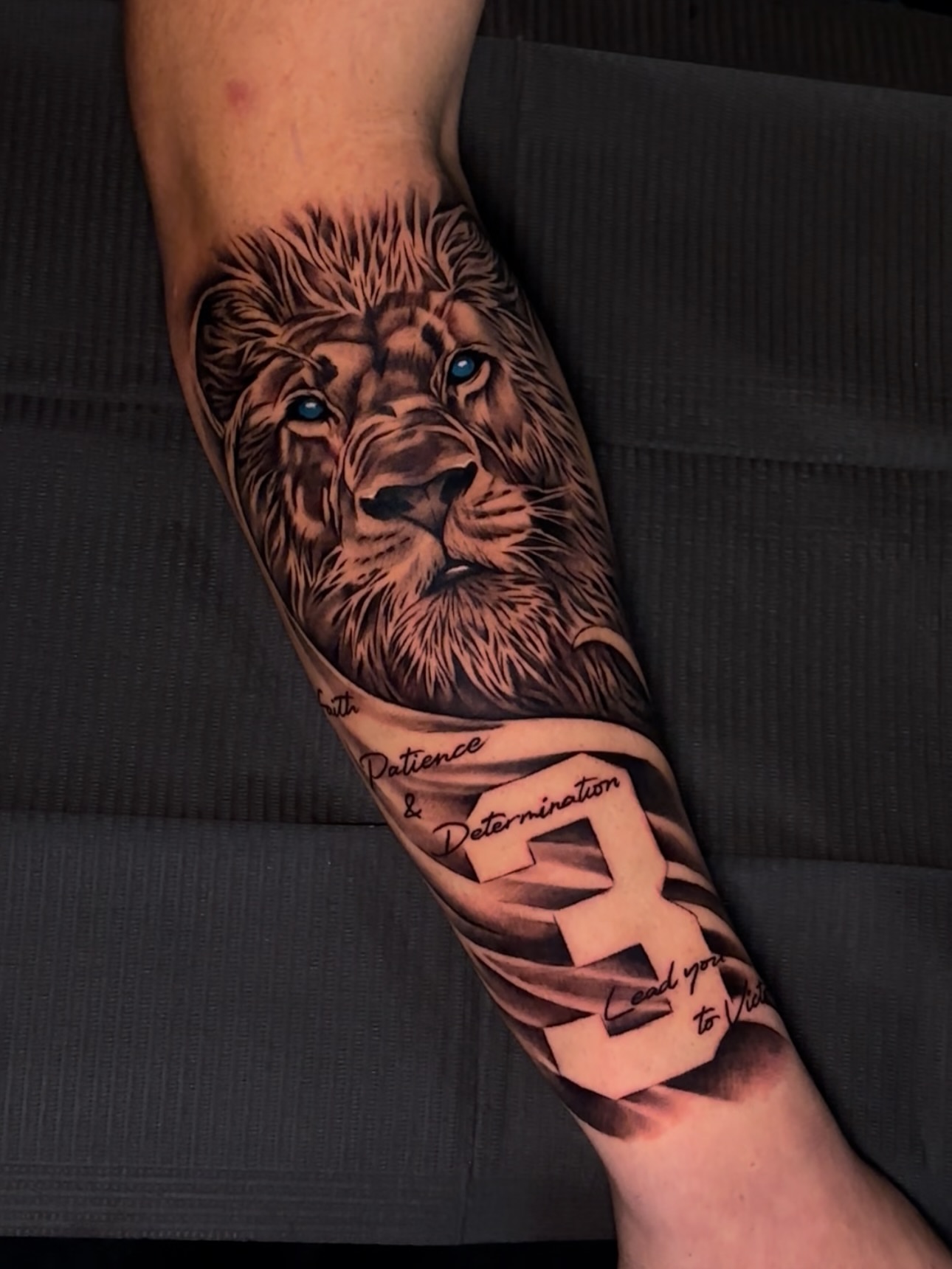 Lion realism tattoo on the forearm by Jay Daartist