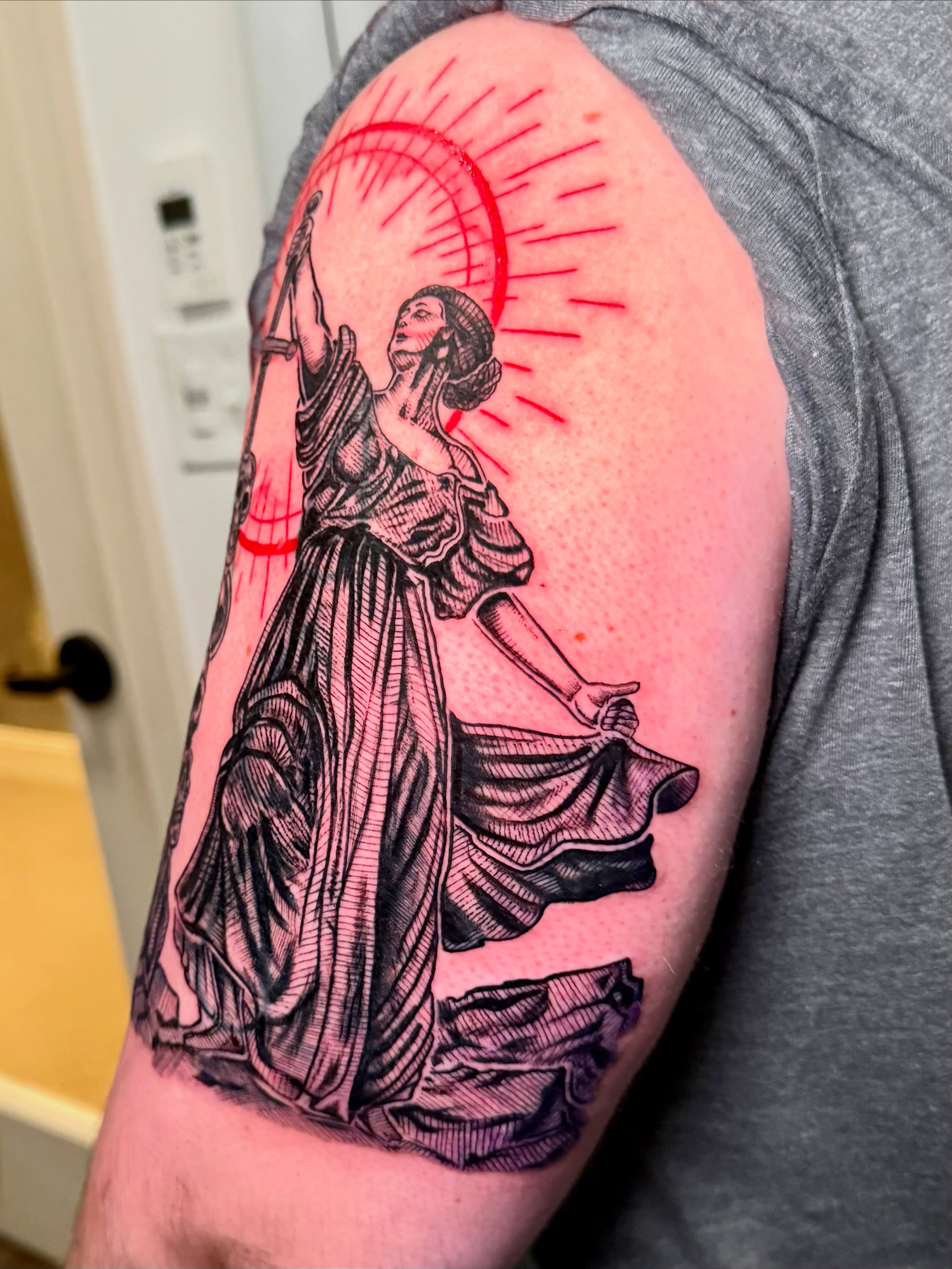 Woman with sword black and grey tattoo on the upper arm by Tatum