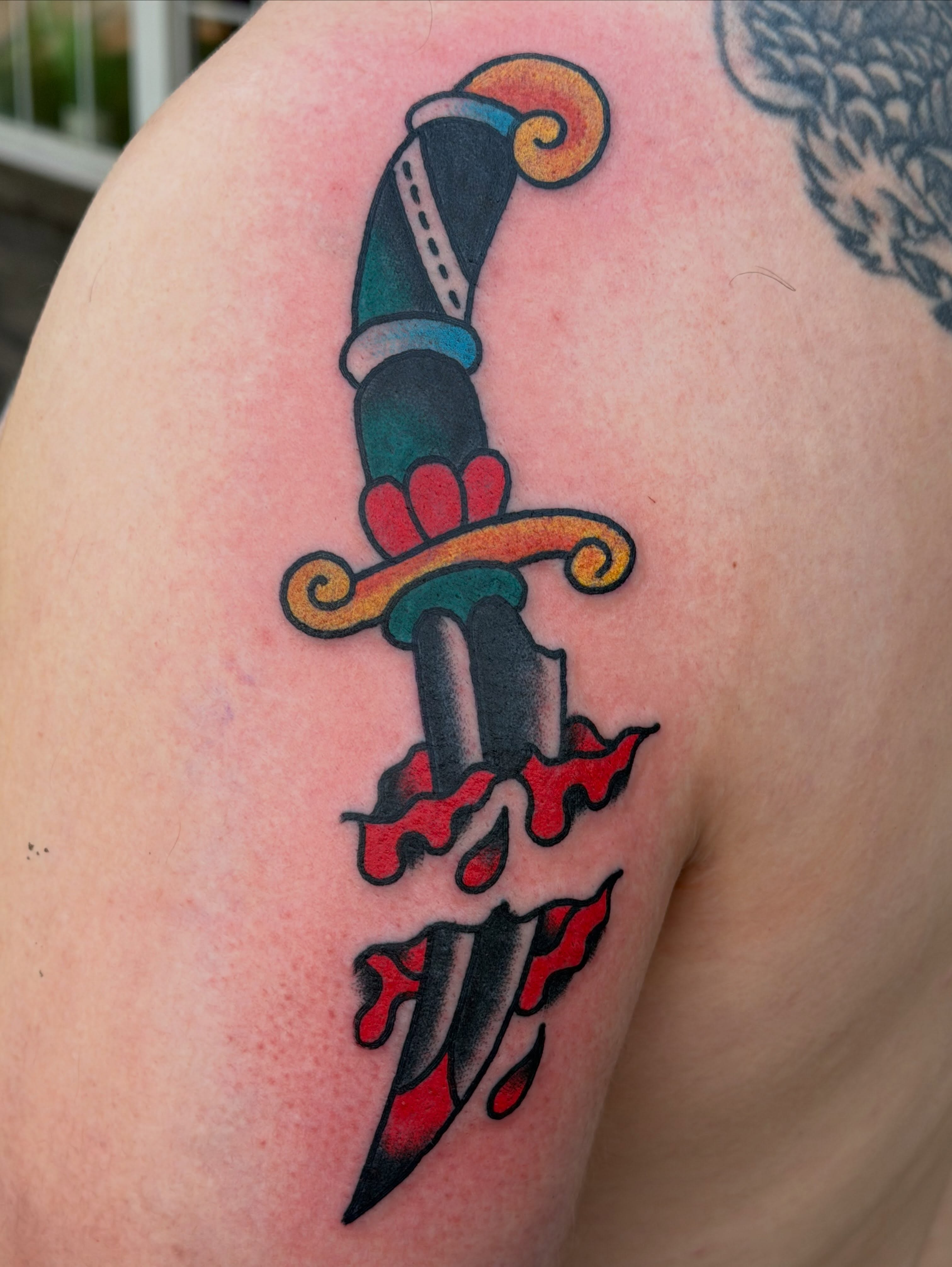 Knife American traditional tattoo on the shoulder by Cody Woolard, Seymour, Tennessee