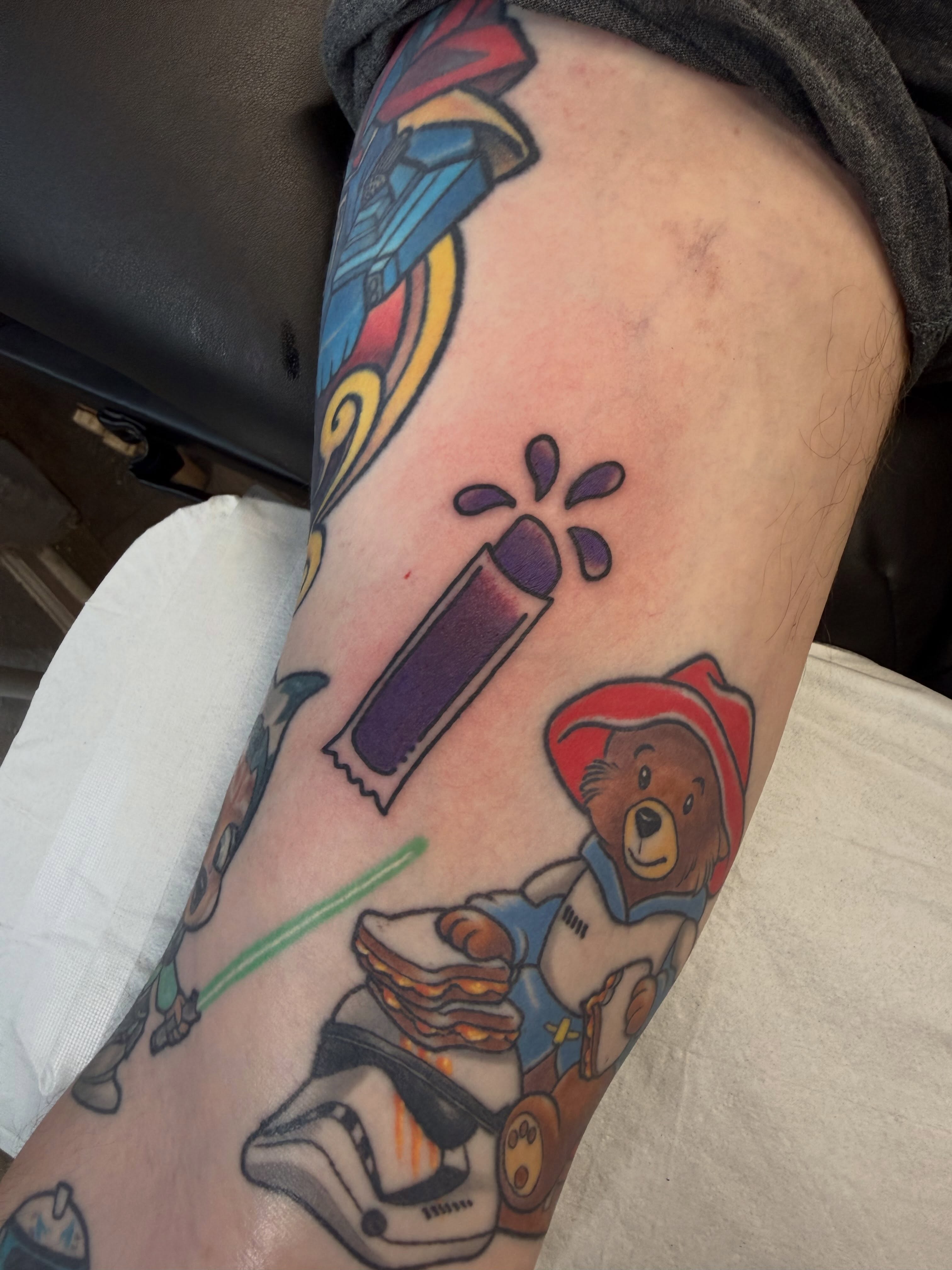 Teddy bear with sandwich American traditional tattoo on the forearm by Chase Martines