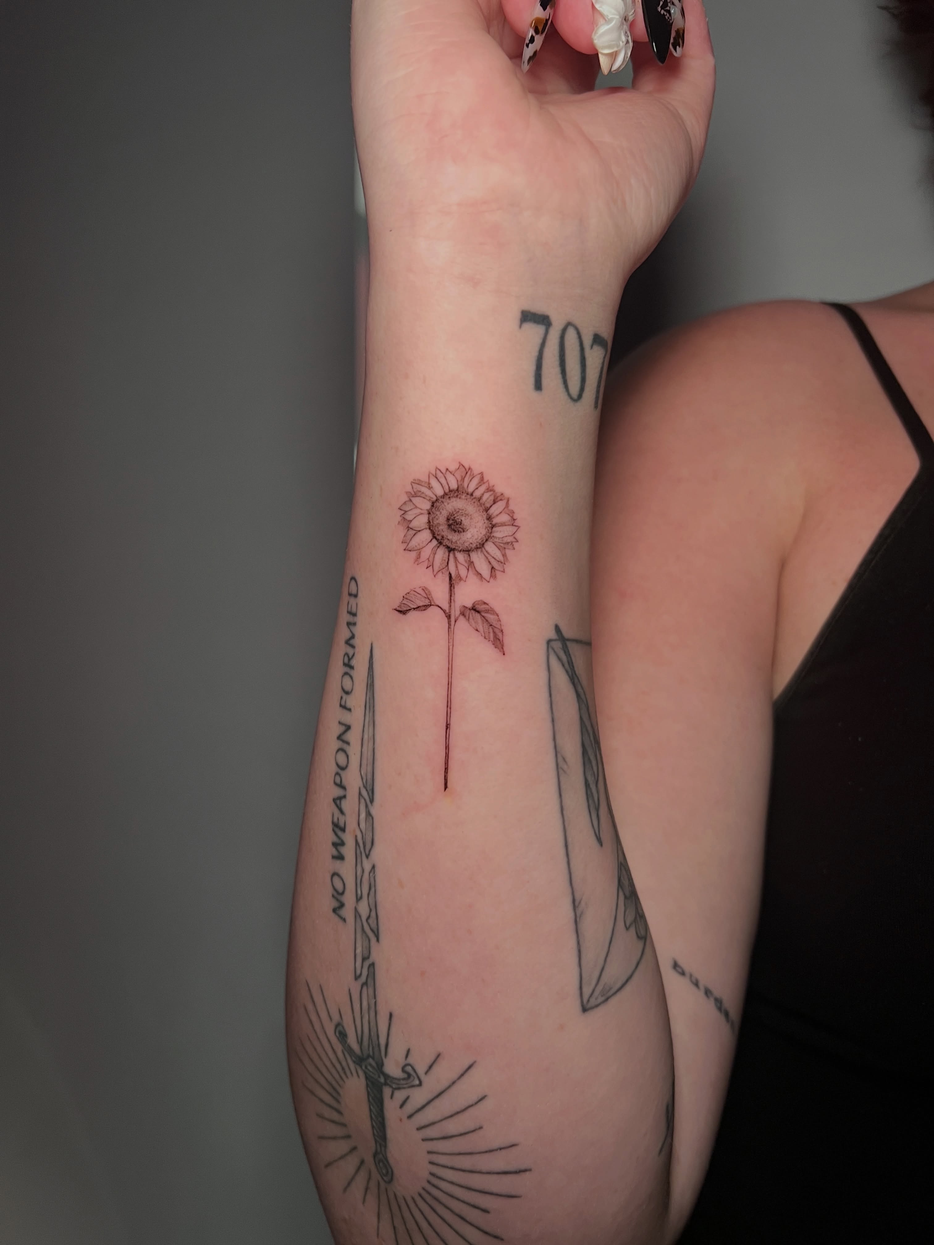 Sunflower black and grey tattoo on the forearm by Eleana, North Miami, Florida