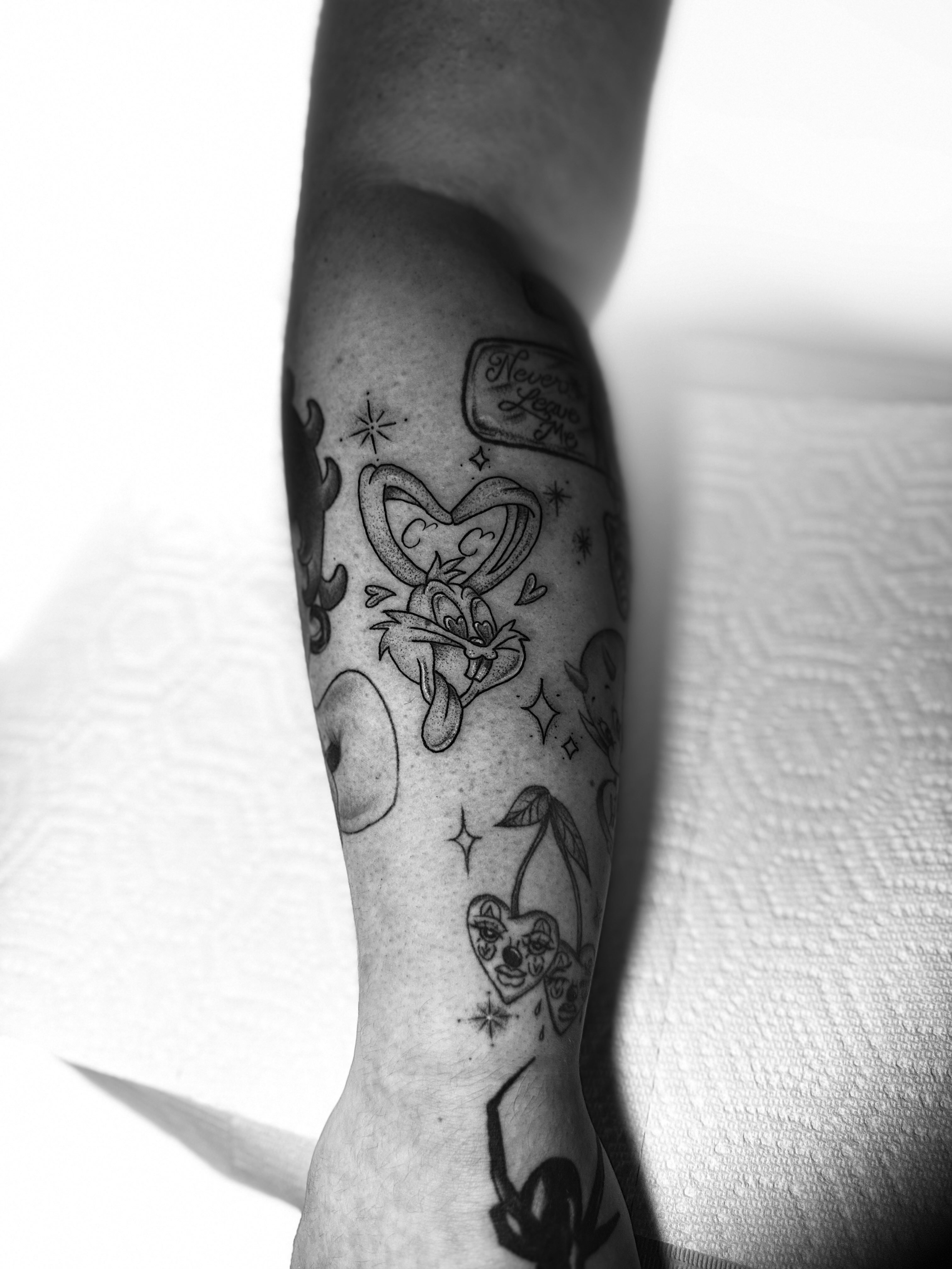 Looney tunes character black and grey tattoo on the forearm by Giana Martinez, Wichita, Kansas