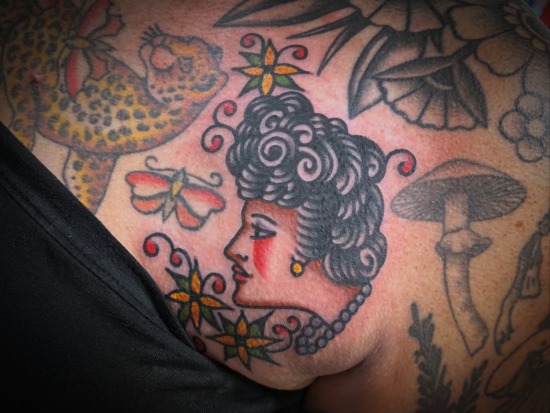 Woman's profile American traditional tattoo on the chest by Deya Aven, Nashville, Tennessee