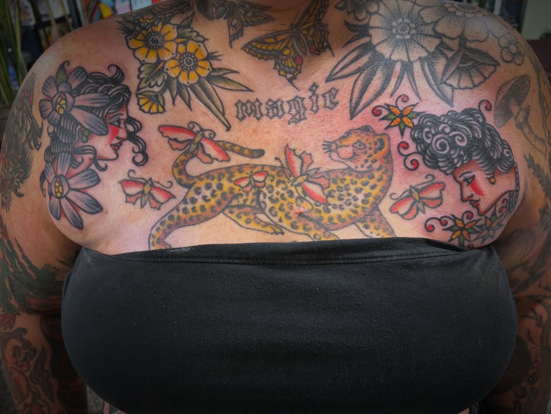Jaguar and faces American traditional tattoo on the chest by Deya Aven, Nashville, Tennessee