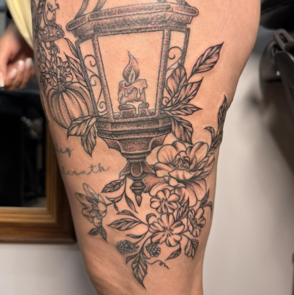 Lantern and floral arrangement dotwork tattoo on the thigh by Destiny A