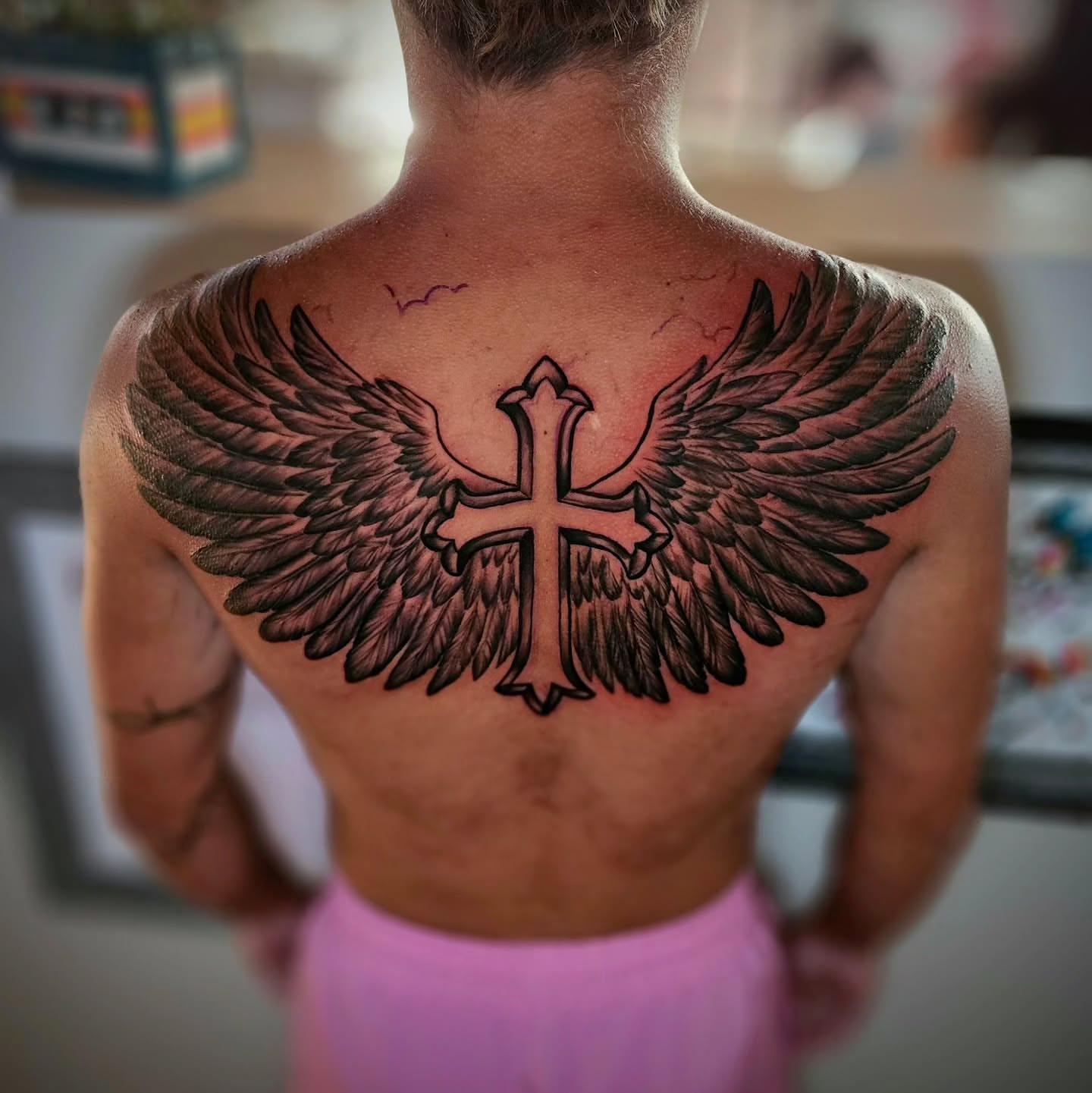 Cross with wings black and grey tattoo on the back by Justin J-rust Smith