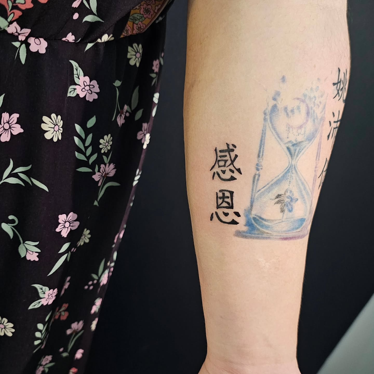 Hourglass and Chinese characters dotwork tattoo on the forearm by Lili Gu
