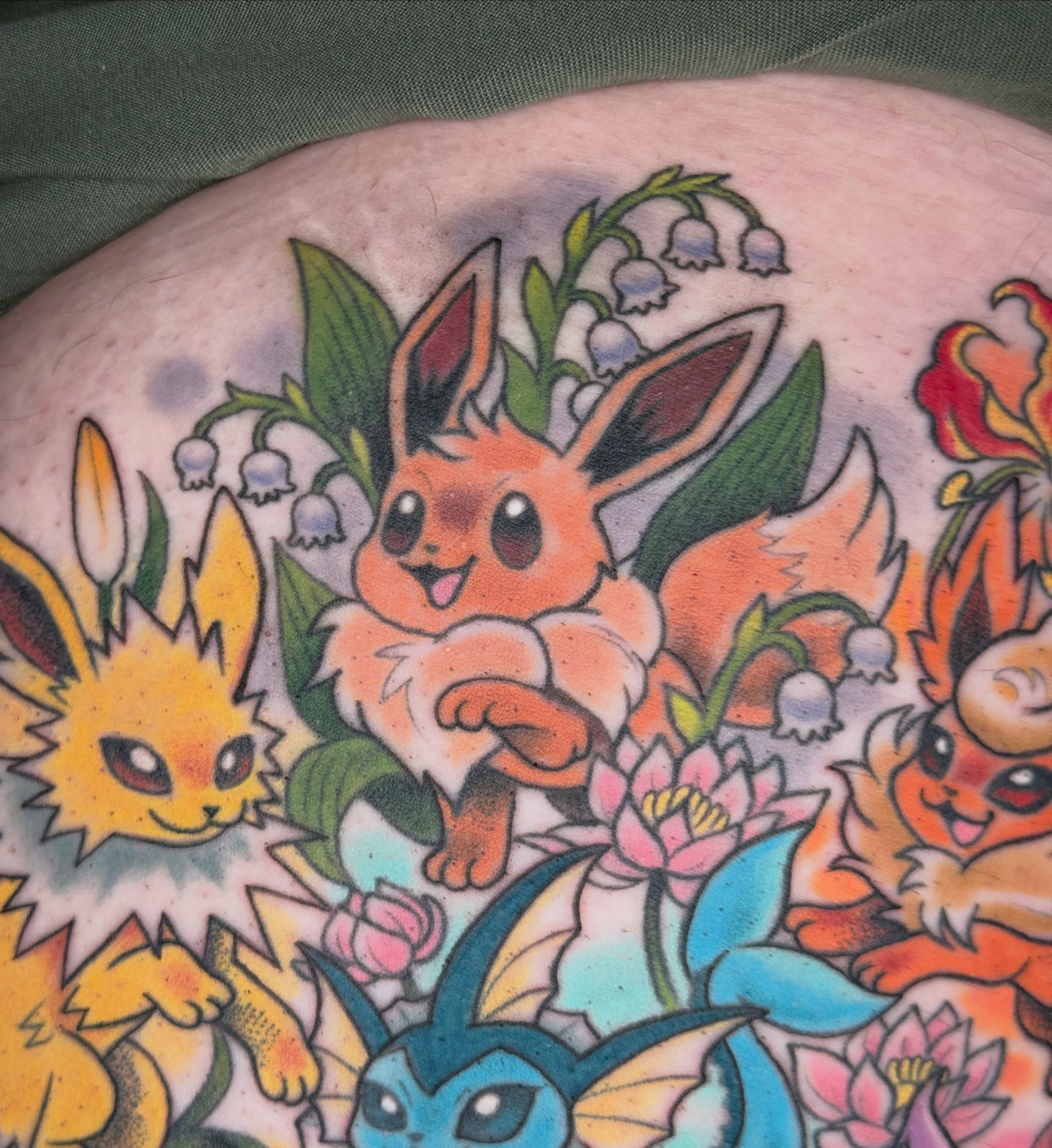 Eevee evolution family American traditional tattoo on the torso by liam u. williams