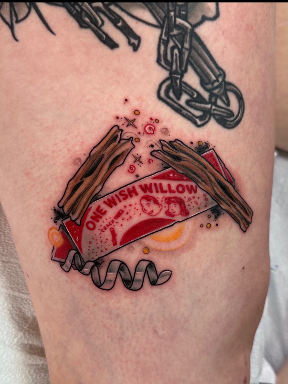 Wishbone and banner American traditional tattoo on the forearm by Teddi Garson