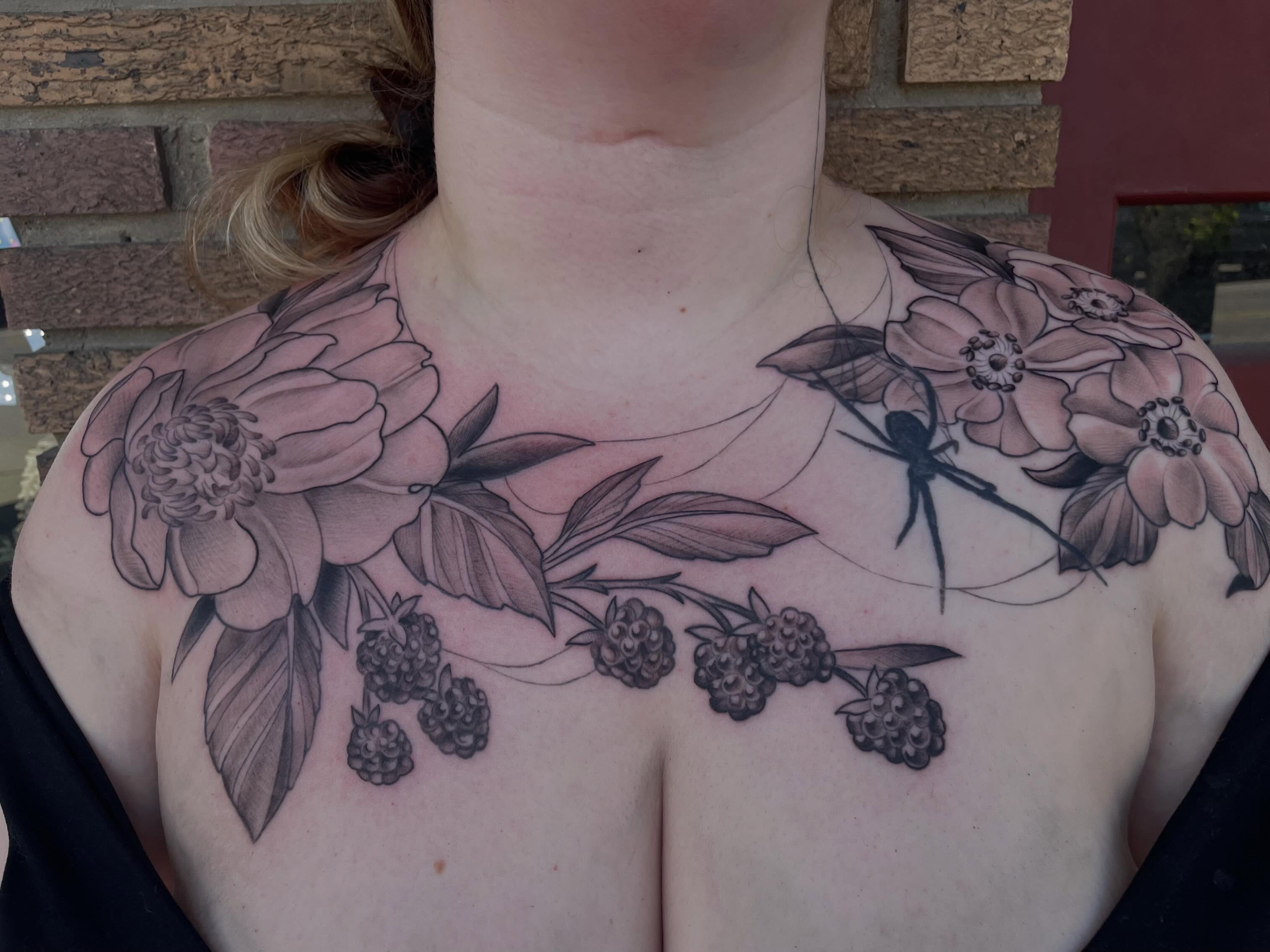 Flowers and spider black and grey tattoo on the chest by Stevie Timmreck, Utica, Michigan