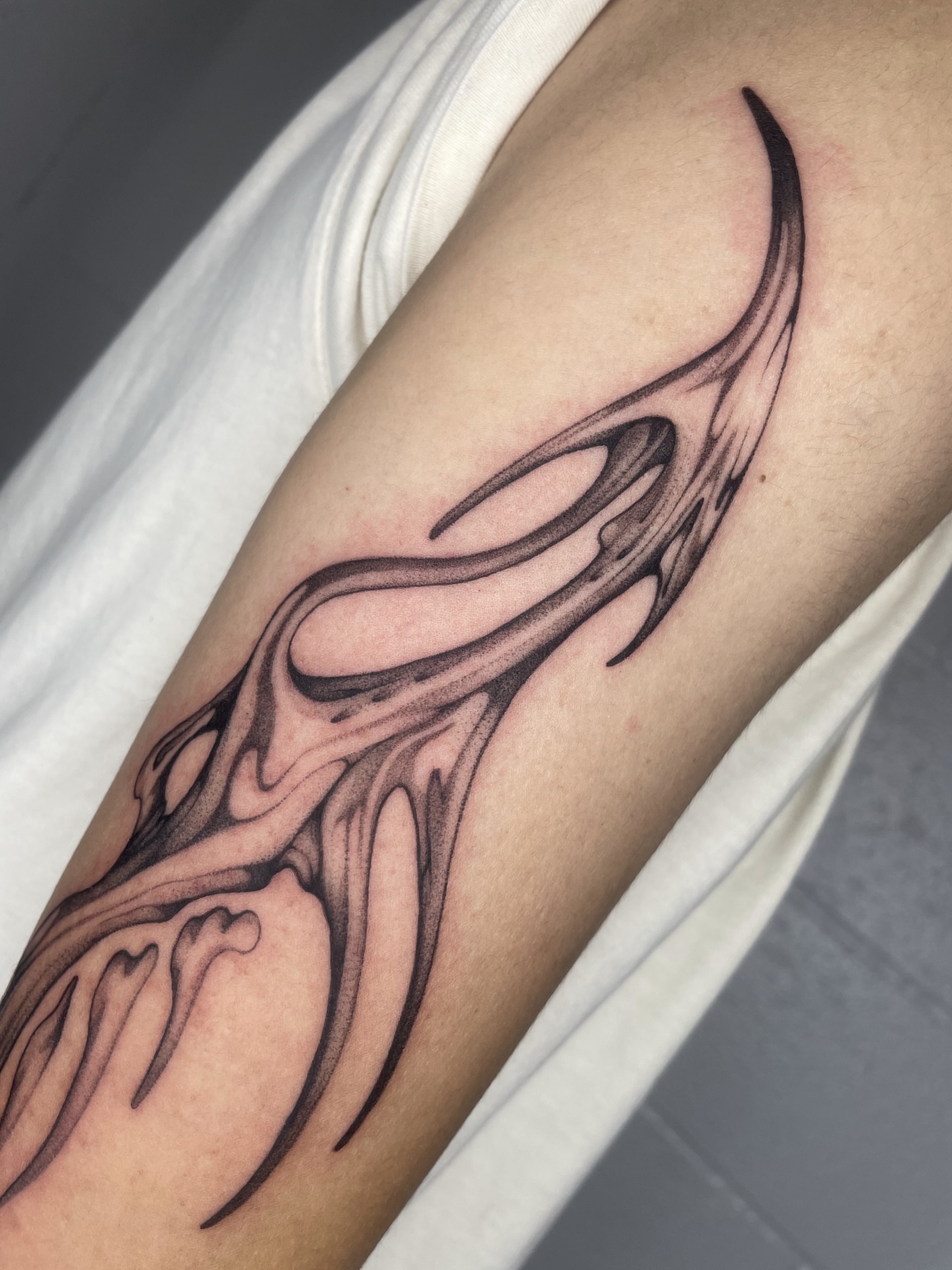 Flame black and grey tattoo on the forearm by 𝕮𝖆𝖗𝖔𝖑𝖎𝖓𝖊 𝕽𝖆𝖊 𝕽𝖔𝖇𝖎𝖓𝖘𝖔𝖓, Los Angeles, California