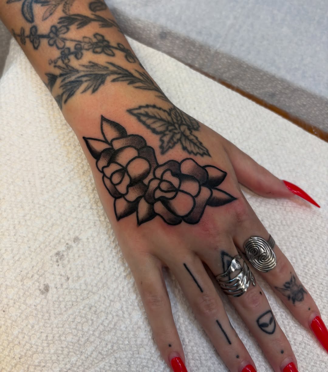 Floral bouquet black and grey tattoo on the hand by Sammy Tattoo, Austin, Texas
