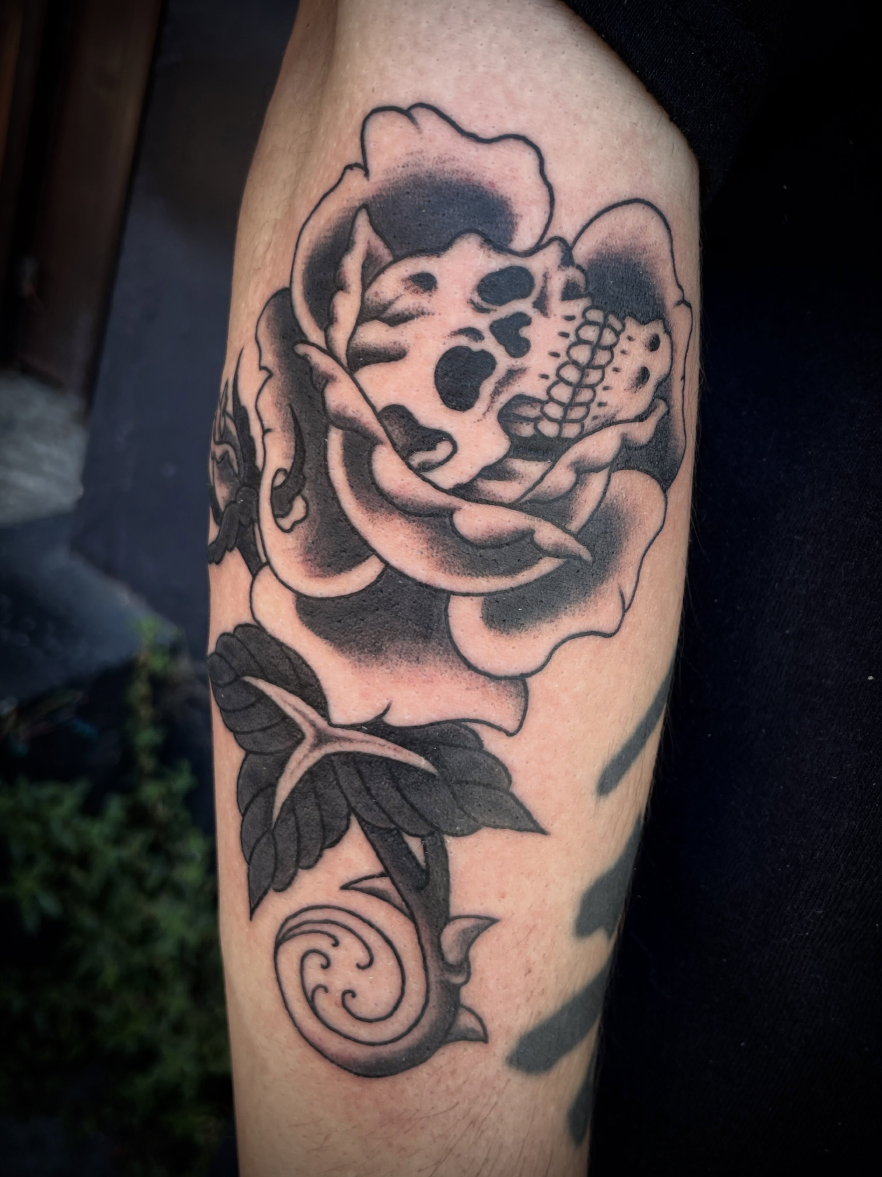 Rose with skull black and grey tattoo on the forearm by Nick Wallin