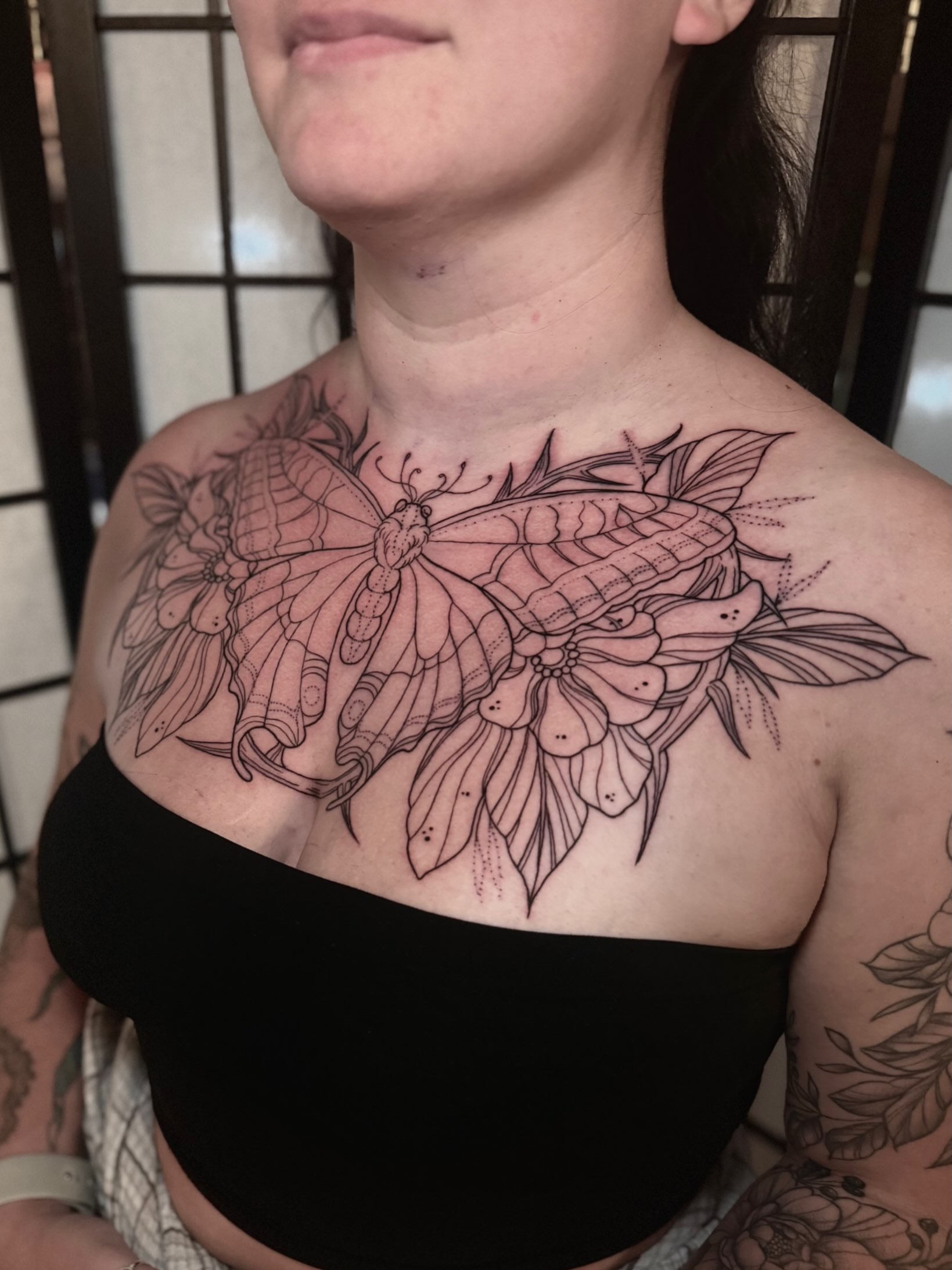 Butterfly and flowers black and grey tattoo on the chest by Abby ✣ fineline and blackwork ✣