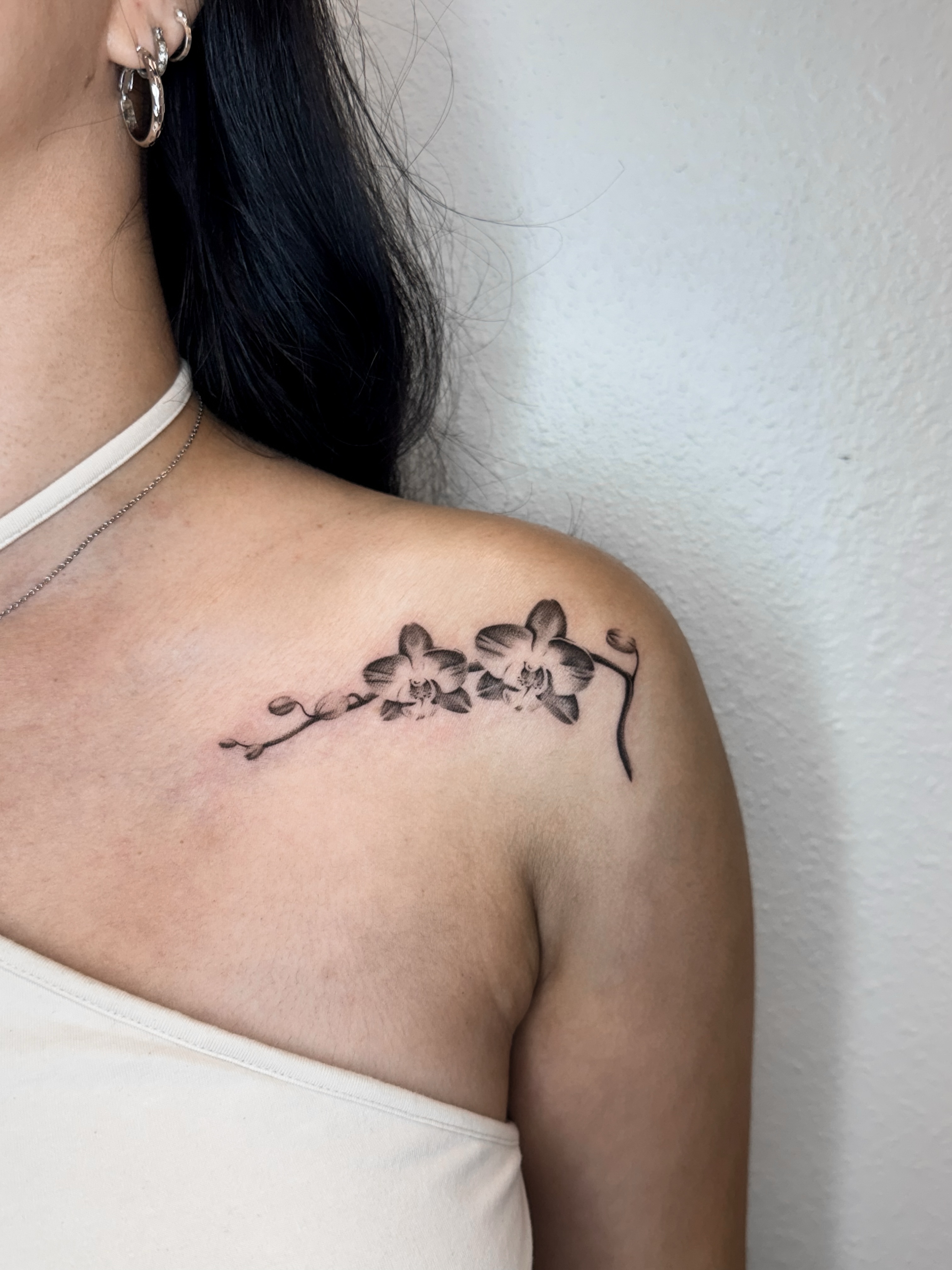 Orchid flowers black and grey tattoo on the shoulder by Rylee
