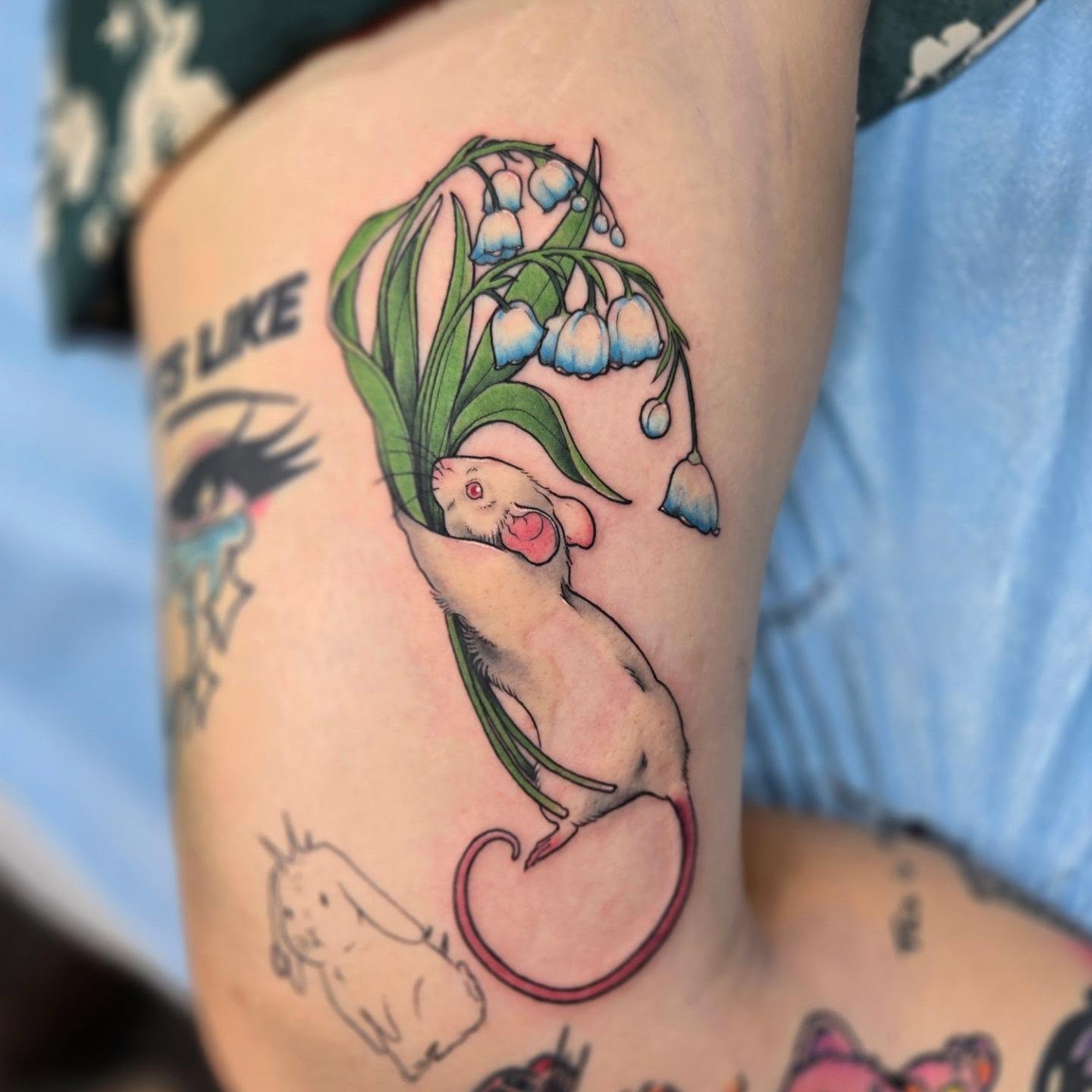 Mouse and lily of the valley illustrative tattoo on the thigh by Britty Love, Nashville, Tennessee