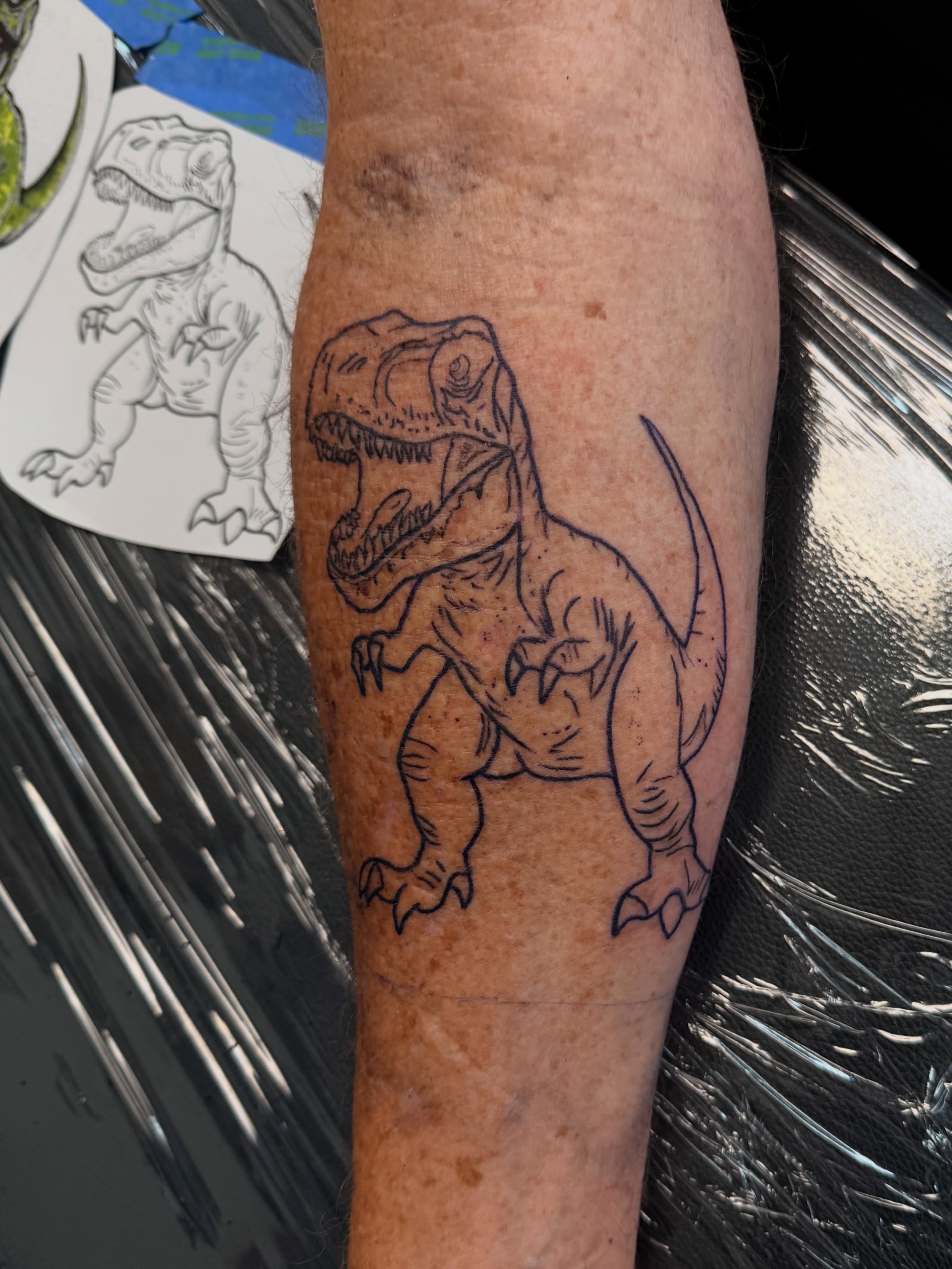T-rex black and grey tattoo on the forearm by Rylan Thorndyke - Tattoo Artist, Las Vegas, Nevada