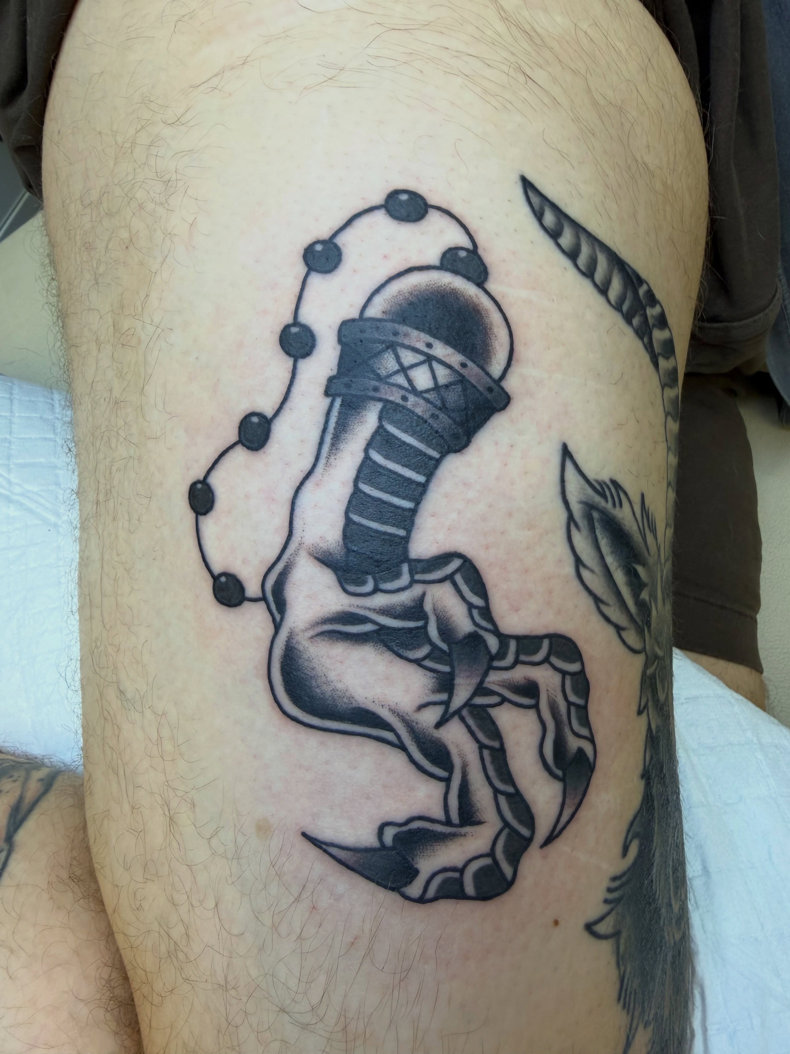 Scorpion black and grey tattoo on the thigh by Nick Tumminello