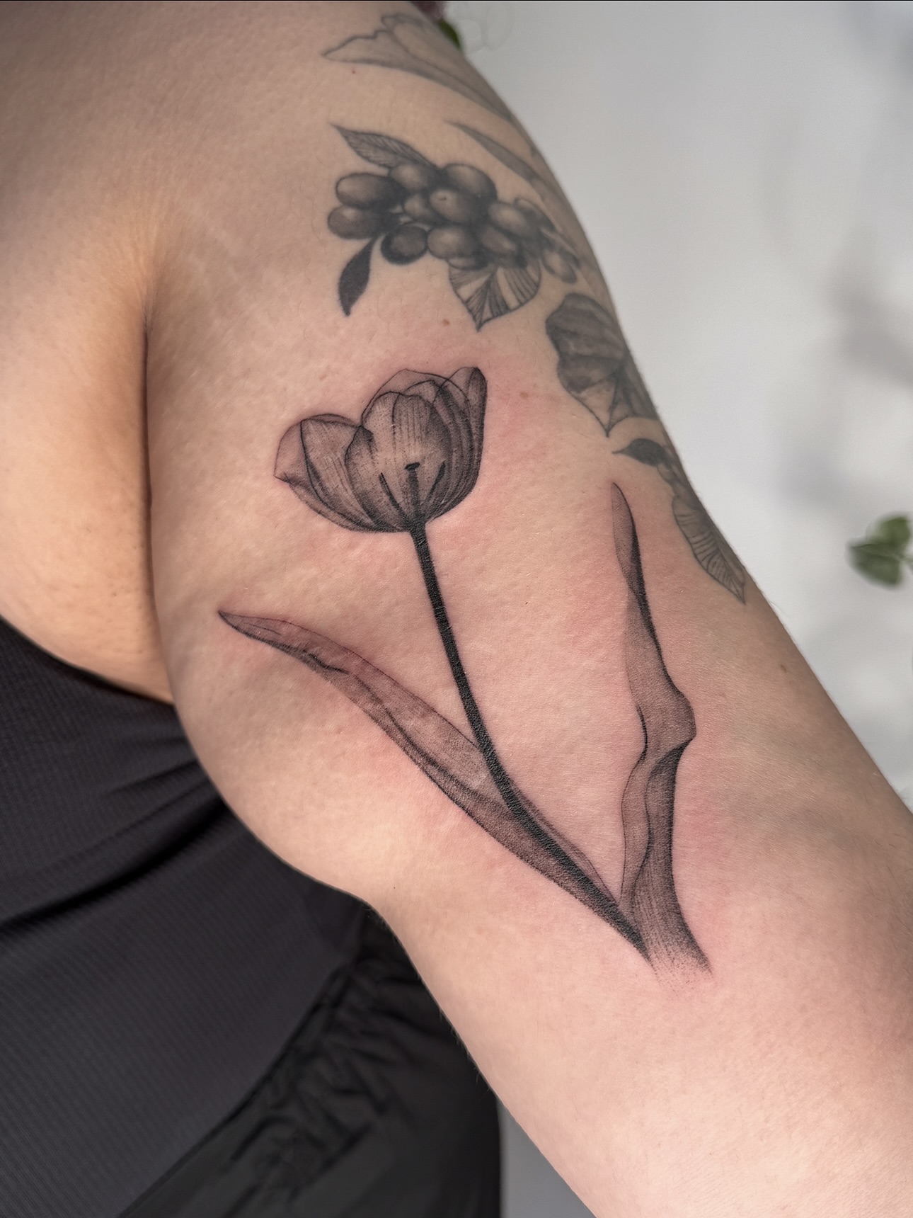 Tulip black and grey tattoo on the forearm by Jasmine, Lynnwood, Washington