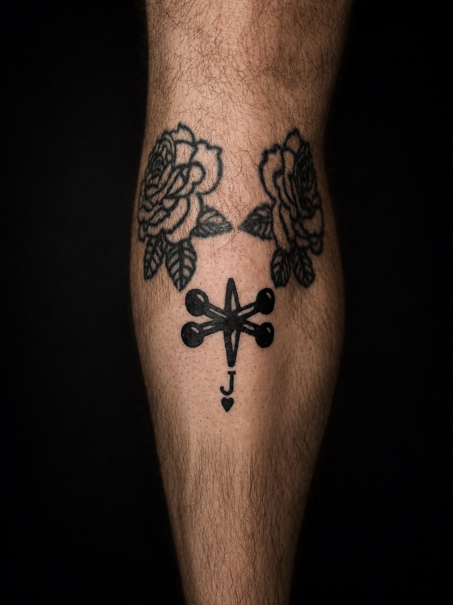 Cross with roses black and grey tattoo on the forearm by 𝚃𝙰𝚃𝚃𝙾𝙾 𝙰𝚁𝚃𝙸𝚂𝚃, Charlotte, North Carolina