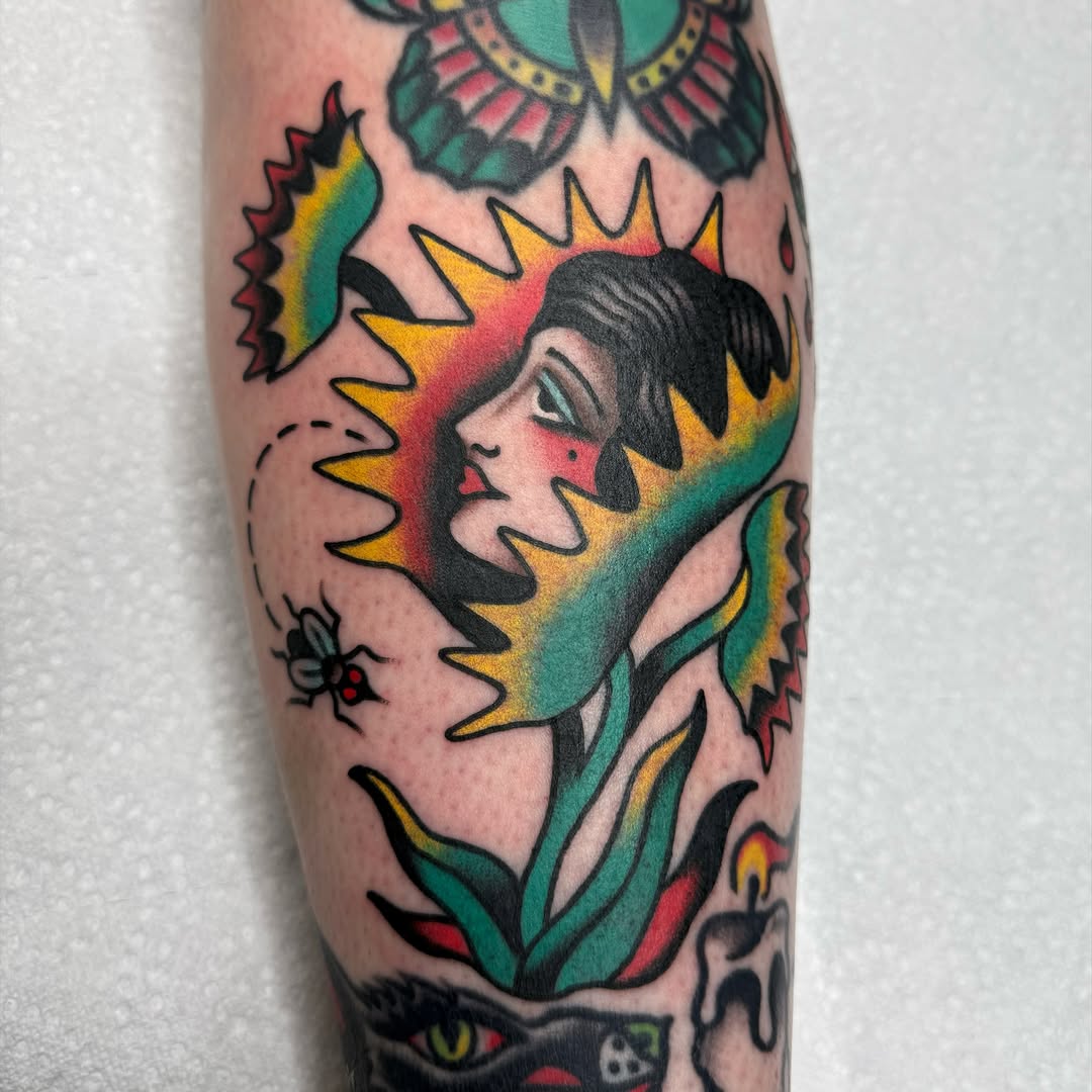 Woman's face with sunburst American traditional tattoo on the forearm by ༺tessa༻