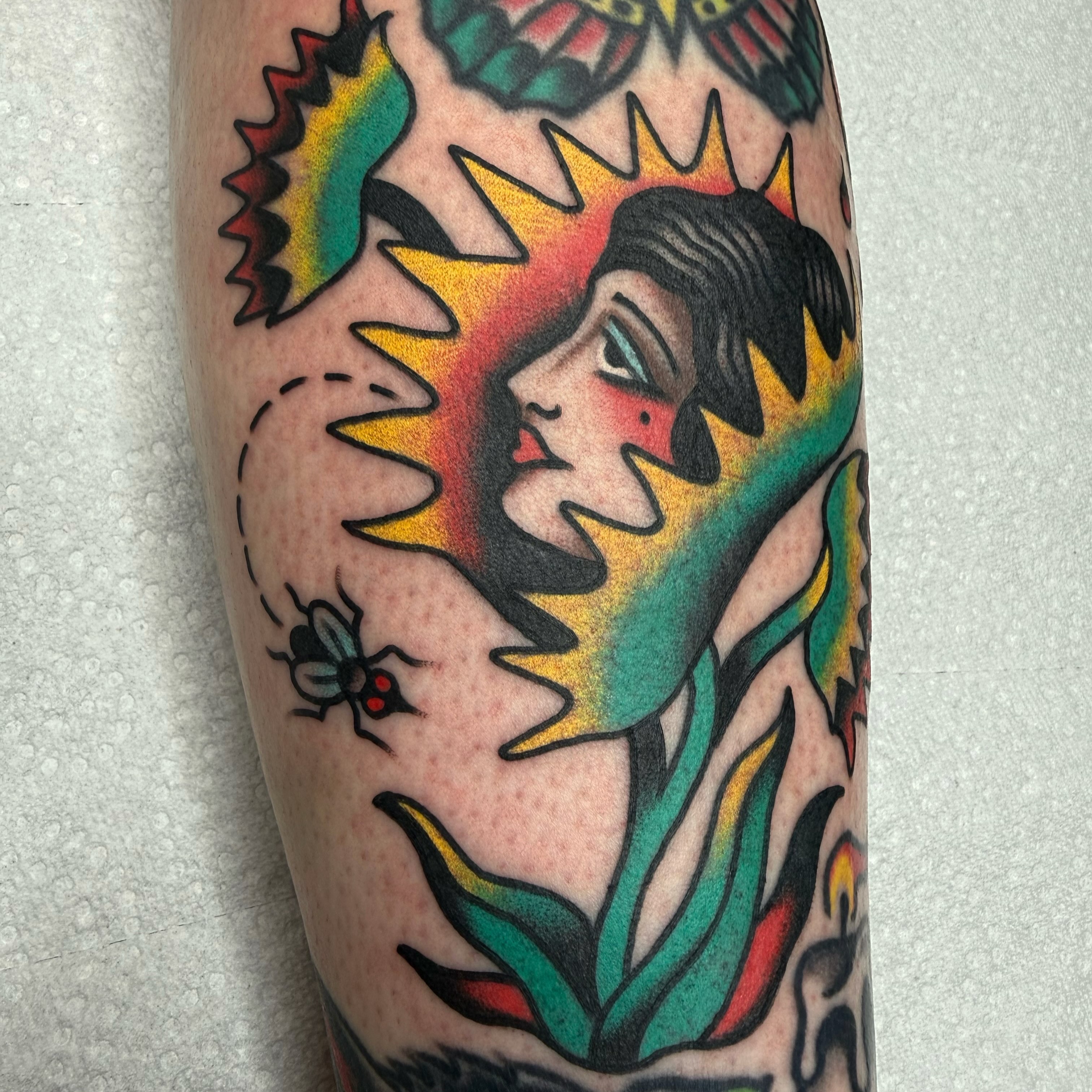 Woman with sunburst American traditional tattoo on the forearm by ༺tessa༻