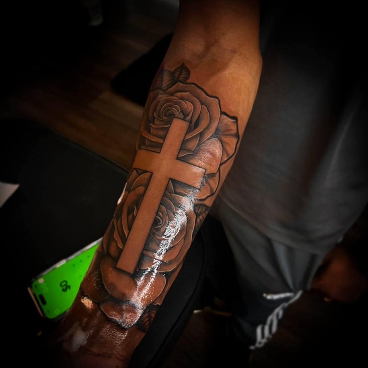 Cross and roses realism tattoo on the forearm by @tattsbyleek