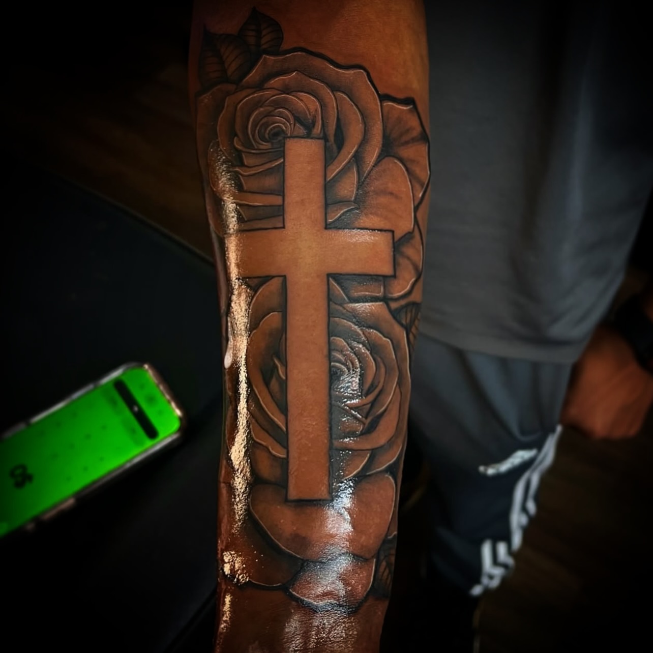 Cross and roses realism tattoo on the forearm by @tattsbyleek