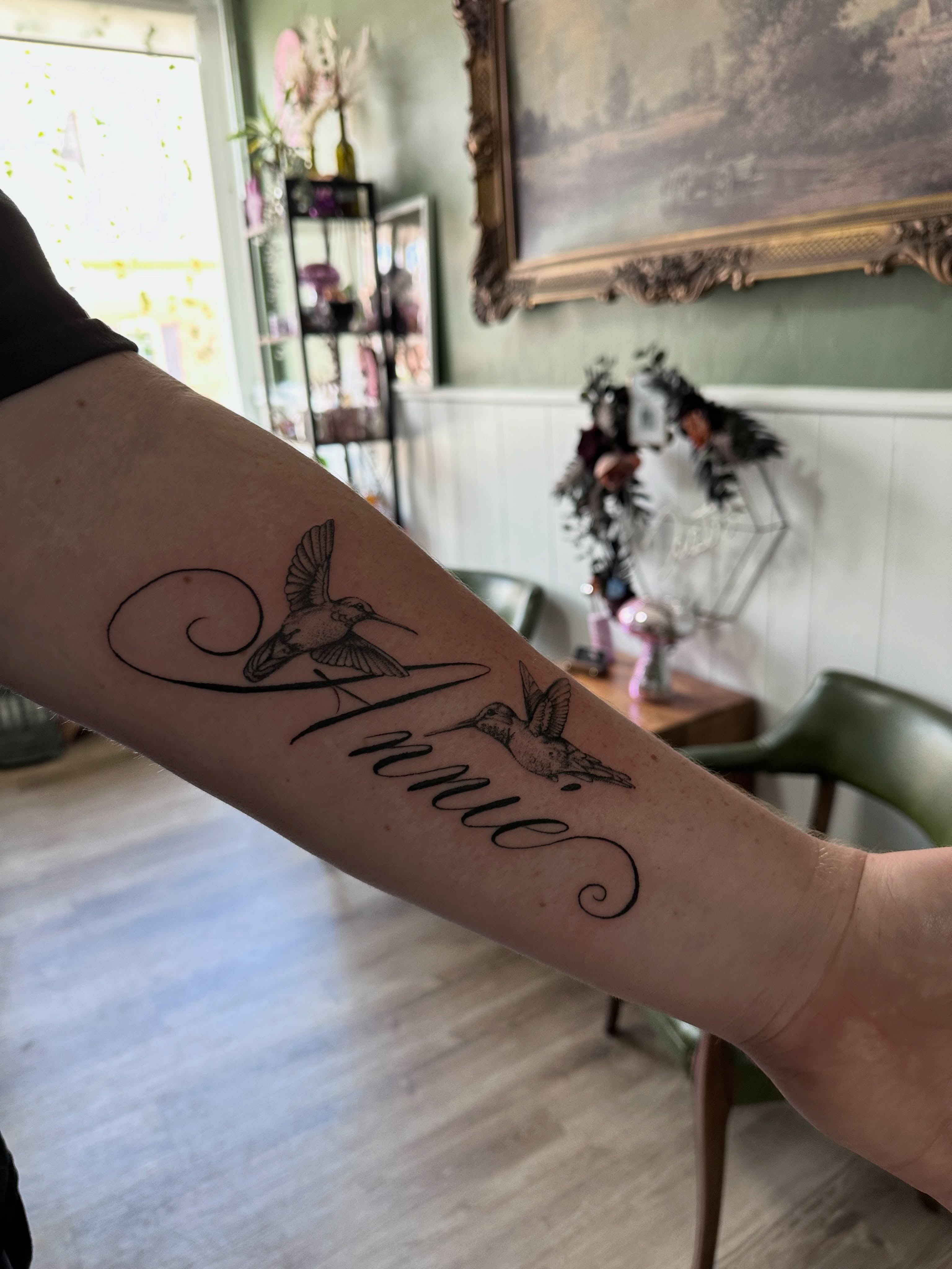 Hummingbirds and name black and grey tattoo on the forearm by Allexis