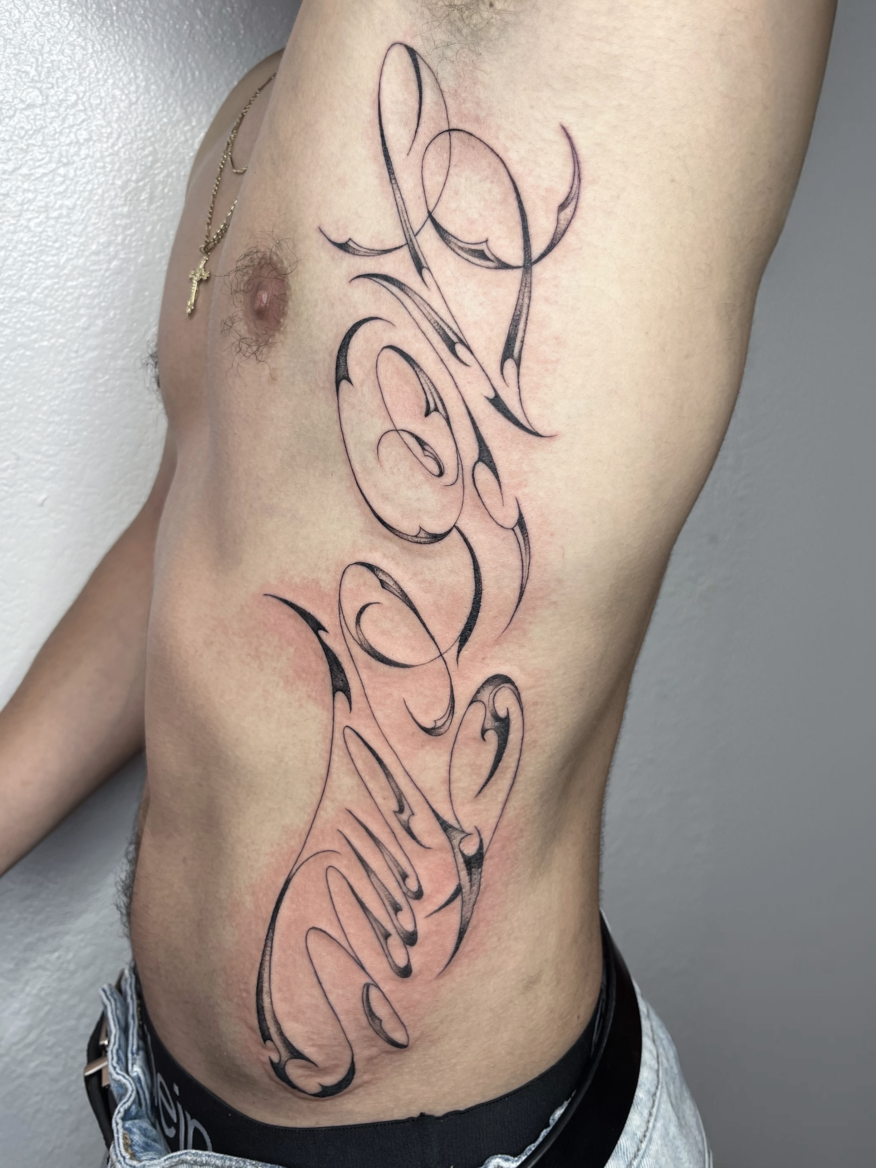 Script lettering lettering script tattoo on the ribs by Sara Atamian, San Diego, California